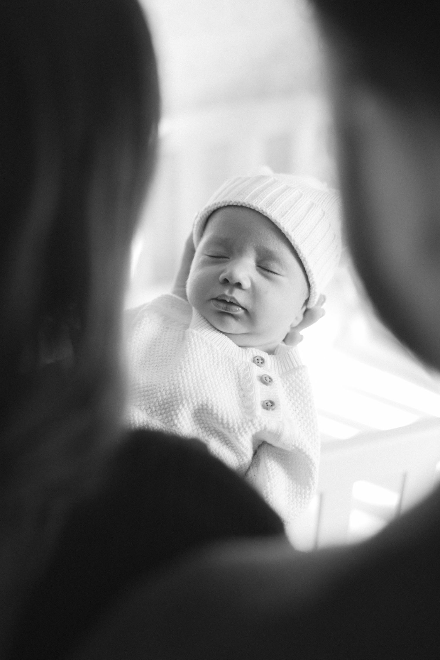 Black and white portrait of sleeping newborn baby wearing knit hat. Family photographer Hannah Rogg Taylor, Kansas City
