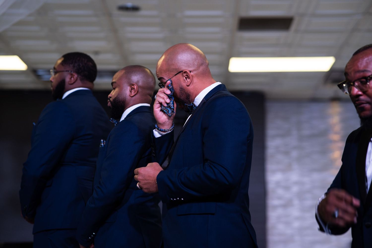 Groomsman wipes tear during Las Vegas wedding ceremony.