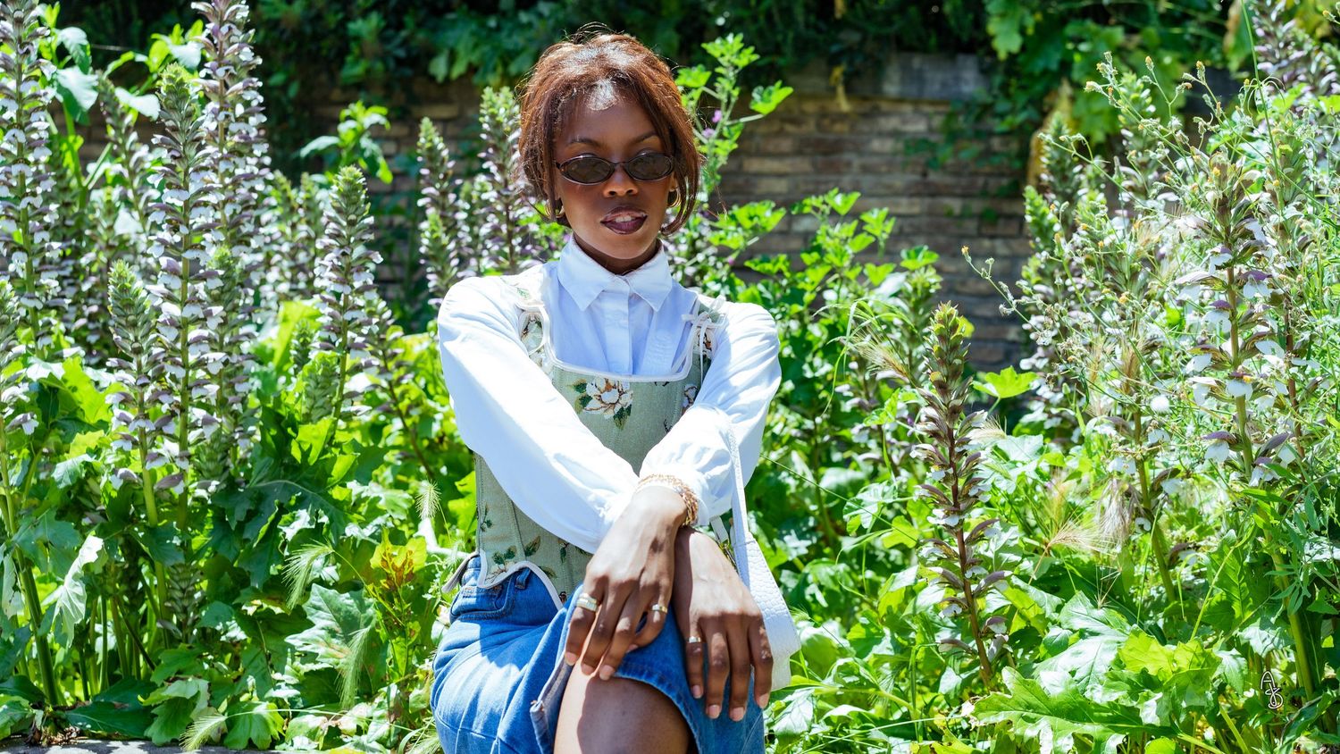 Women in corset posing in flower field.