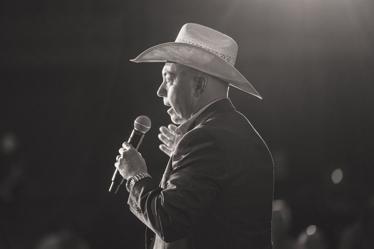 Black and white concert performance photos showing dramatic stage lighting and performers with microphones.