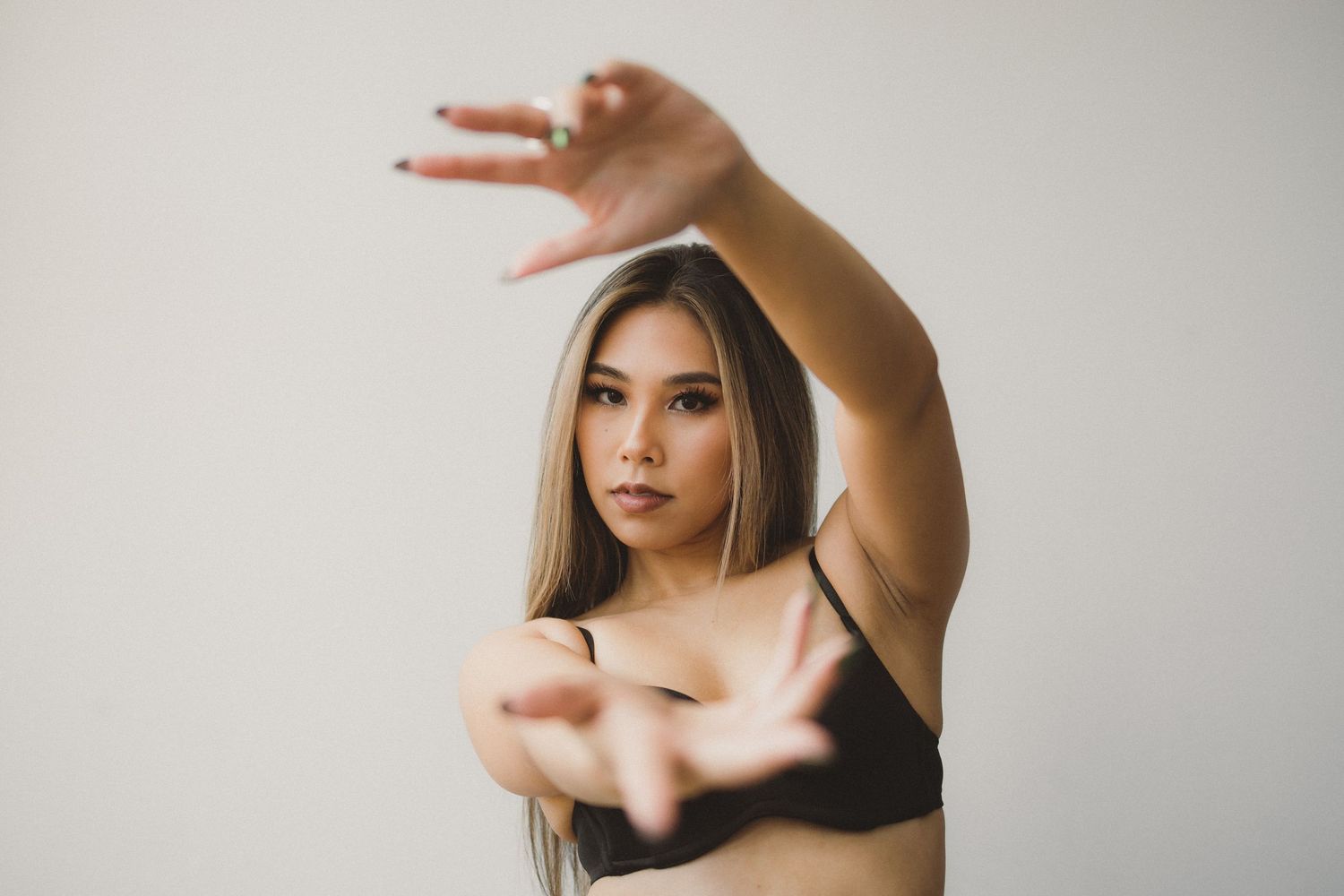 Artistic dance-inspired poses captured against minimalist white studio setting.