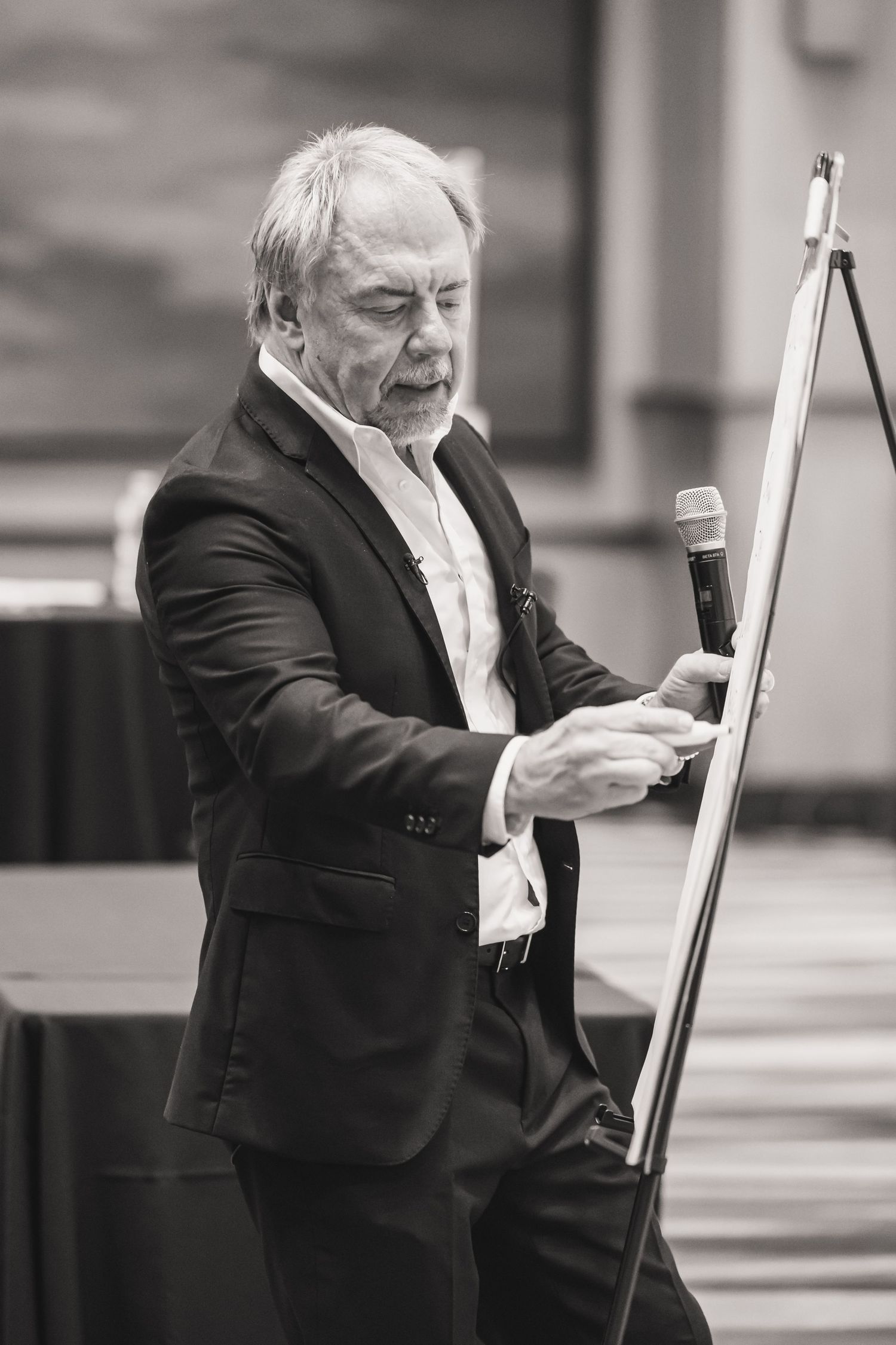 Series of black and white photos showing someone in formal attire gesturing animatedly.