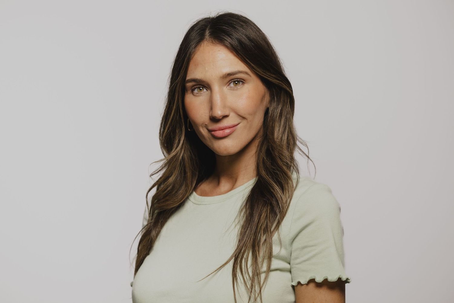 A series of studio portraits showing someone in a casual mint green top against a light background.