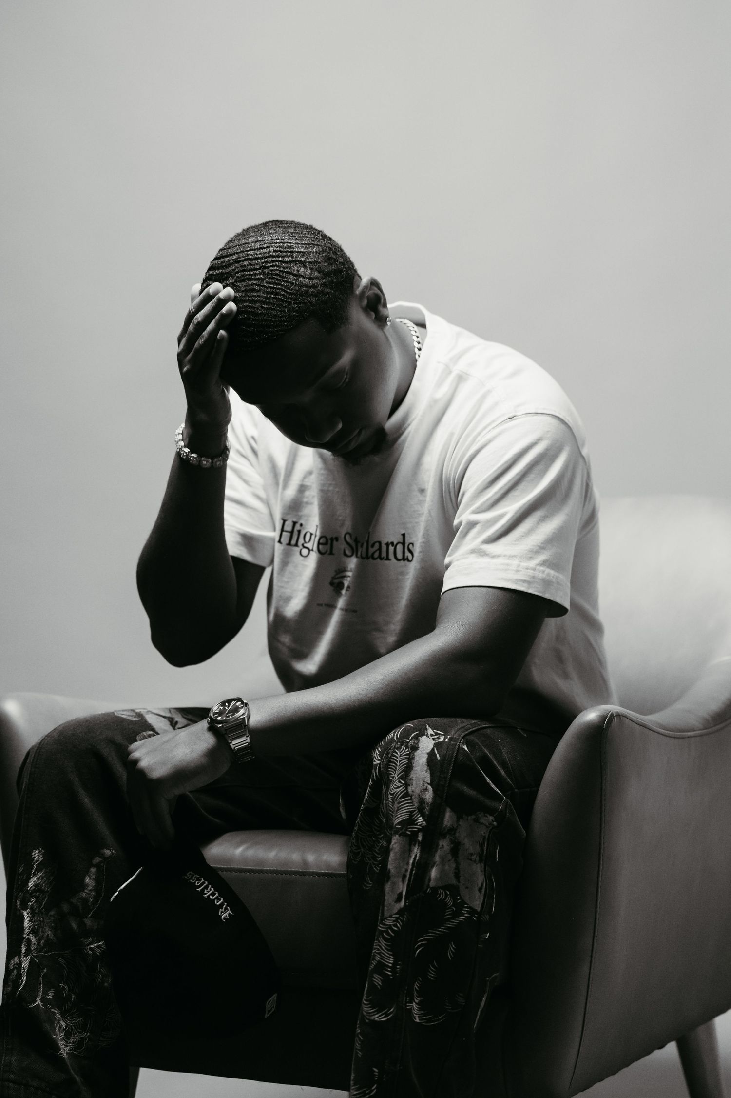 Black and white portrait series showing someone in emotional distress sitting on a couch.
