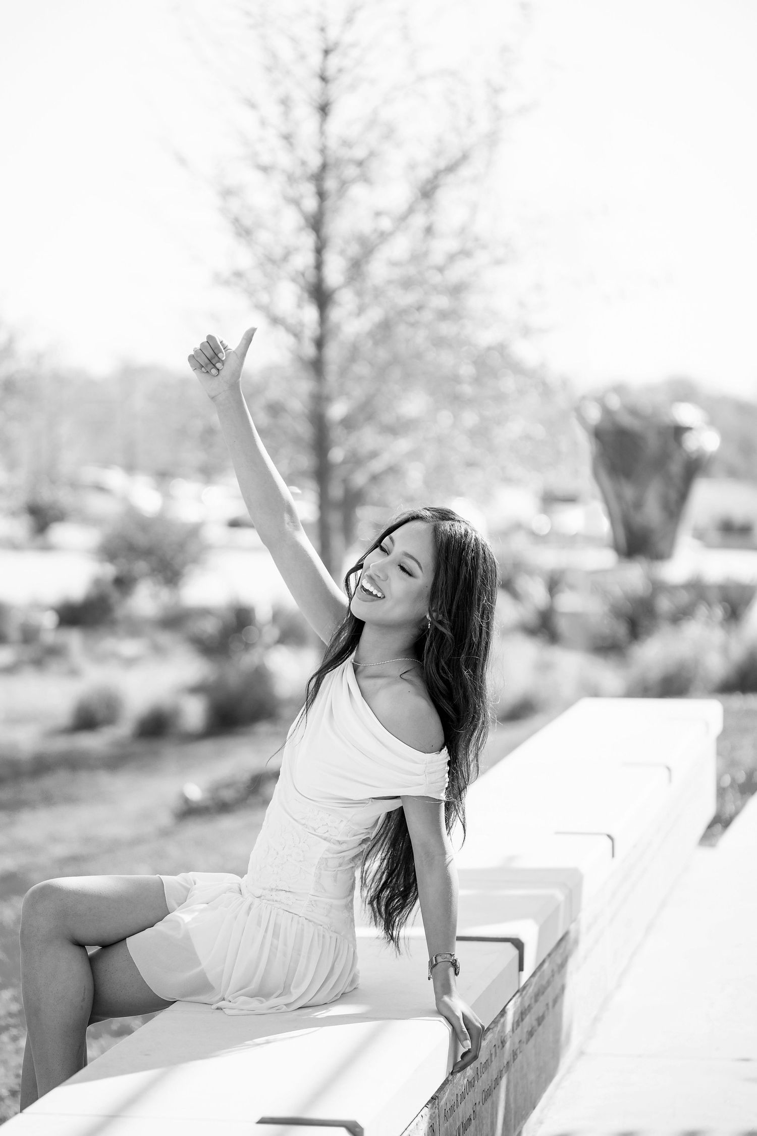 Dreamy black and white portraits show carefree poses in white dress.