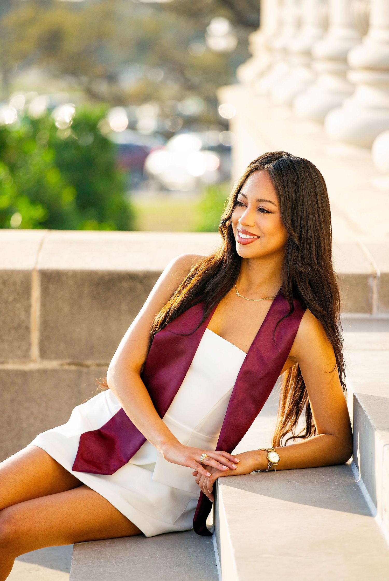 Graduation photos taken outdoors with stone architecture and natural lighting.