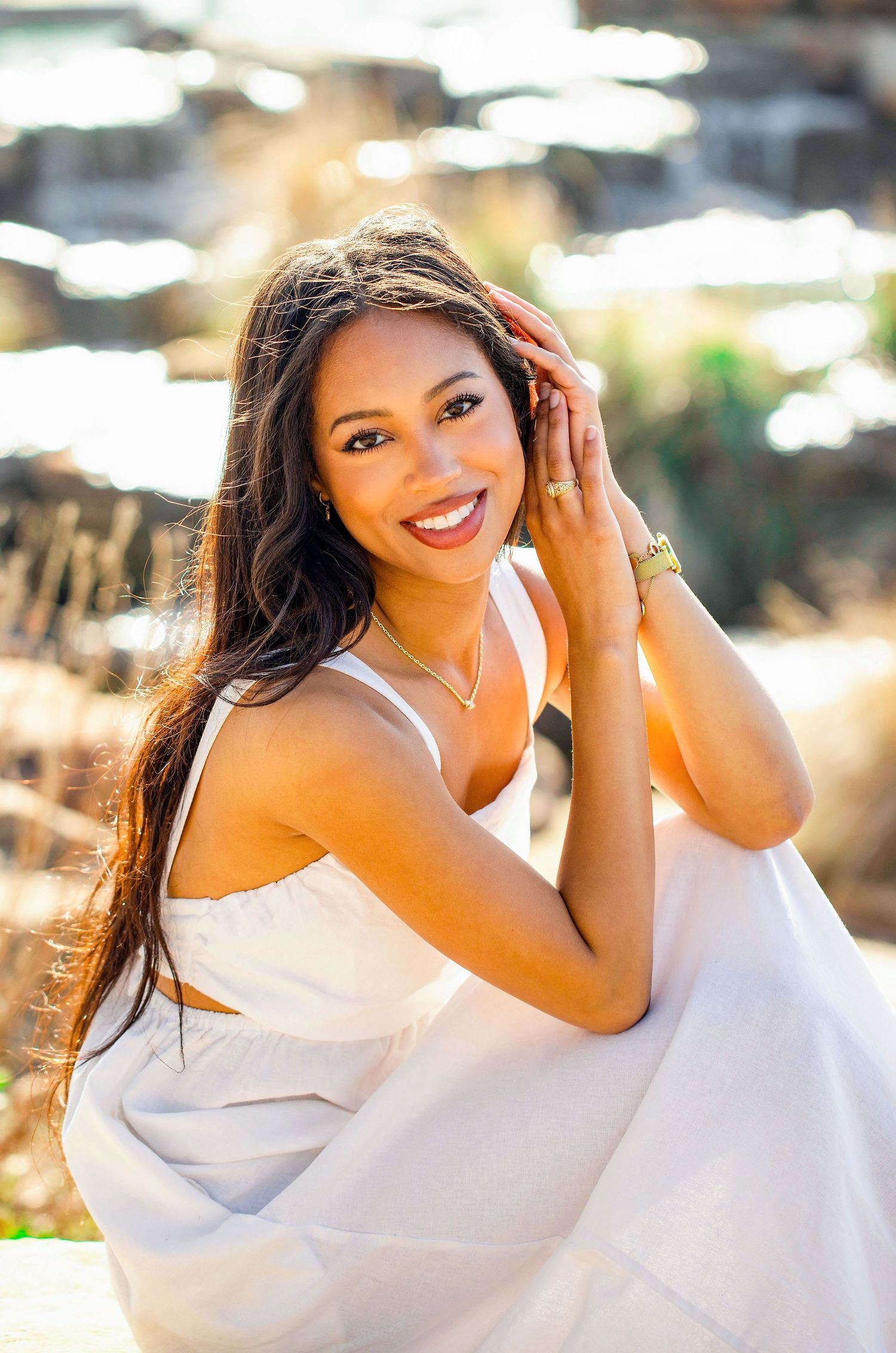 Portrait session in white dress with natural sunlight creating a warm glowing effect.