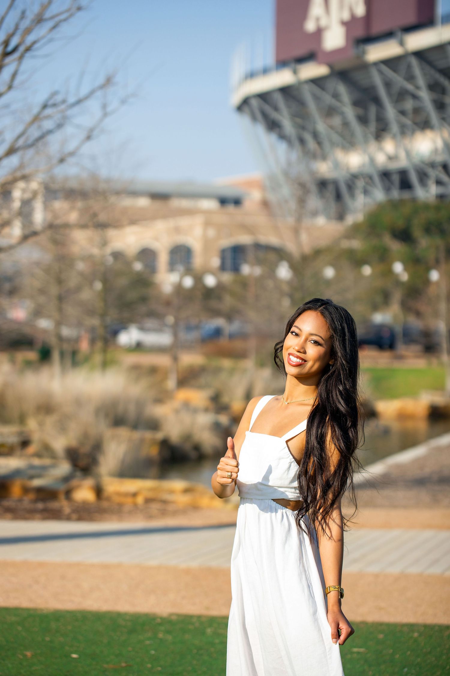 Casual outdoor portraits captured near a college stadium on a sunny day.