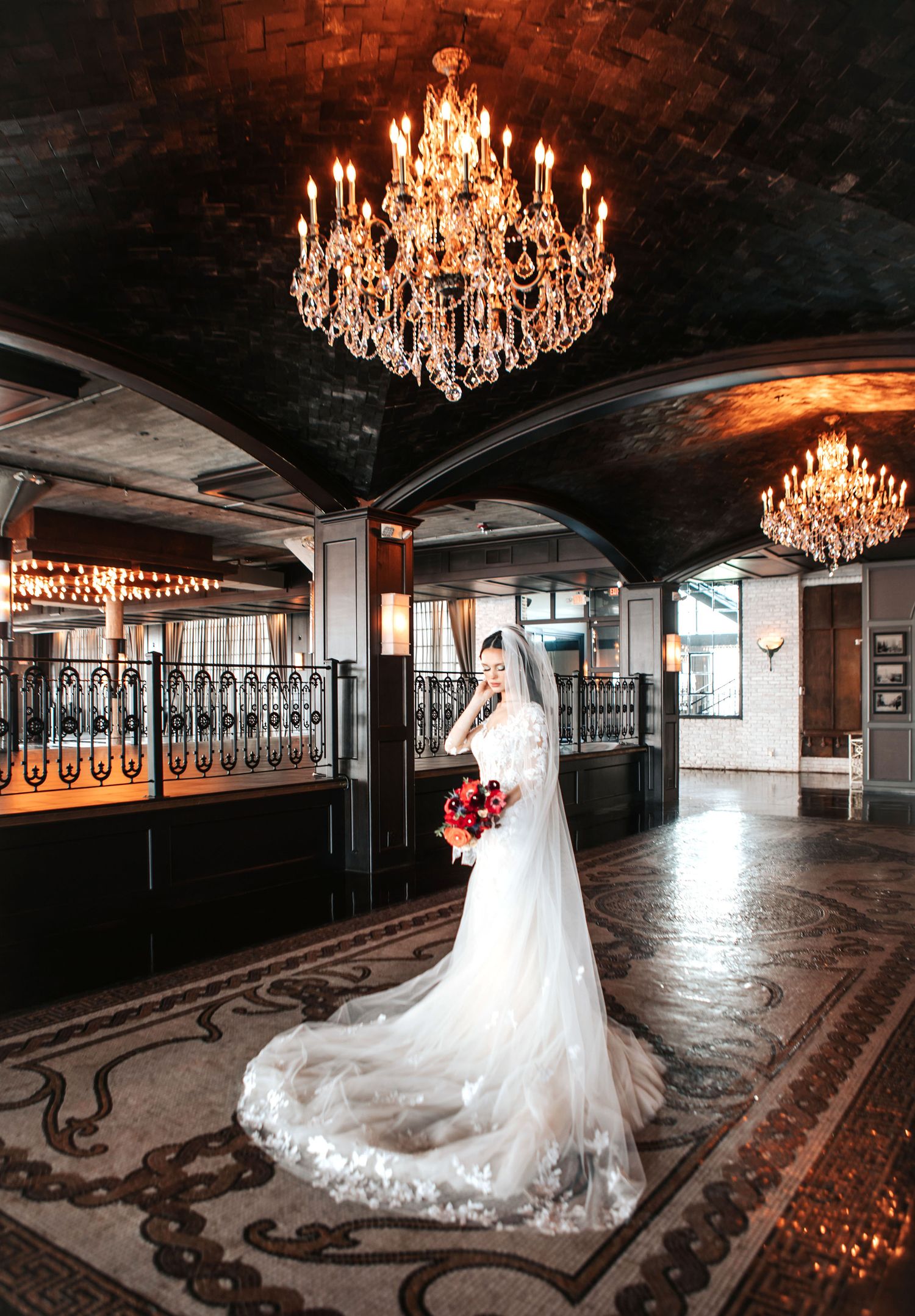 Elegant ballroom with crystal chandeliers showcases a flowing white wedding dress in a series of dramatic angles.