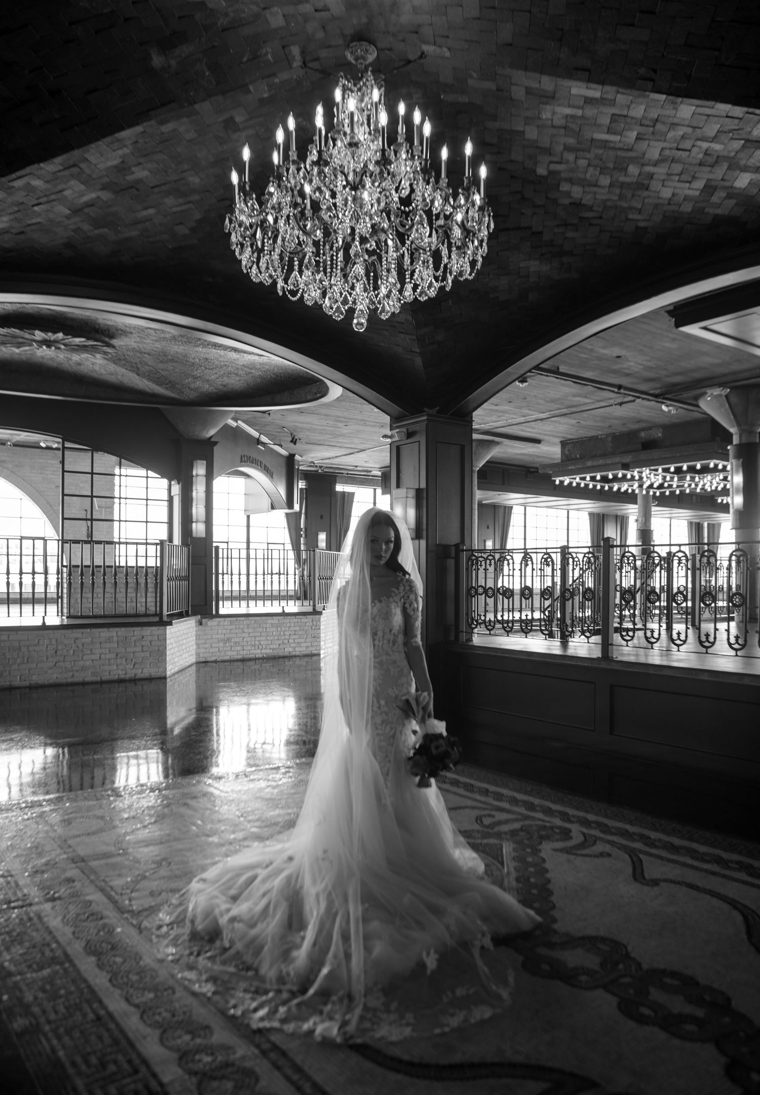 A black and white panoramic sequence showing a grand ballroom with chandeliers and a figure in a flowing gown.