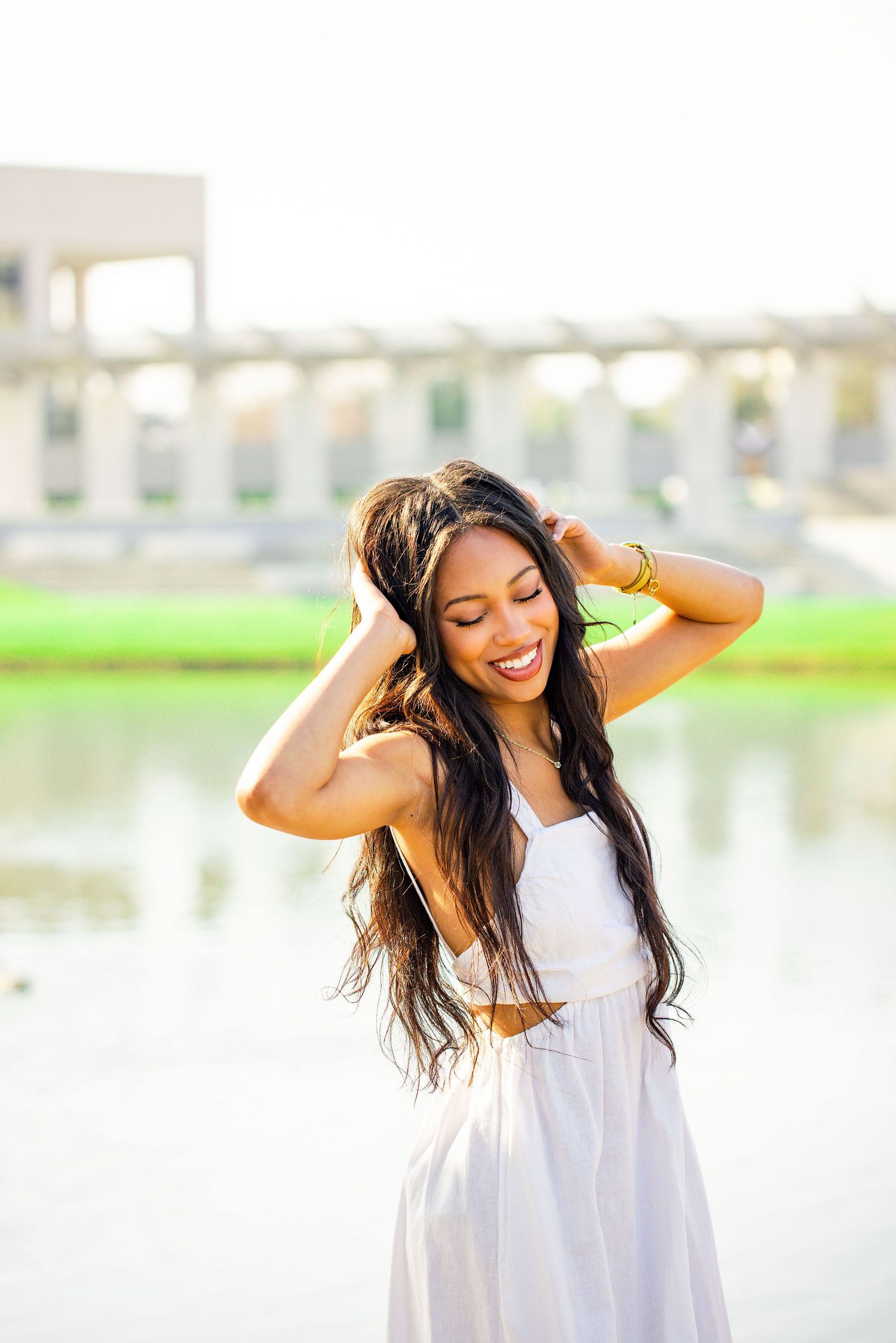 Dreamy portrait session by a reflective pond with soft natural lighting.