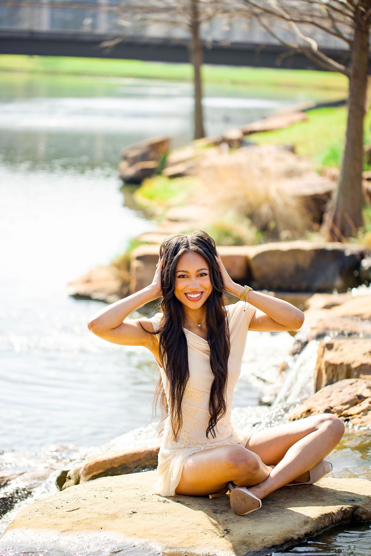 Natural outdoor photography session on rocky terrain near a serene lake.