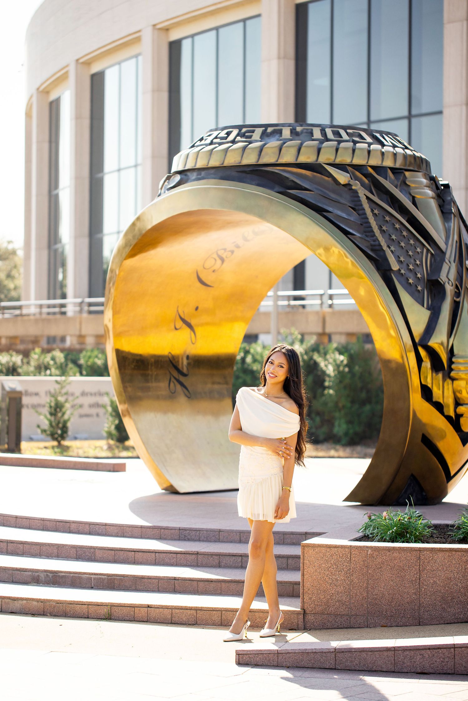 Creative portraits taken through curved architectural features with modern building backdrop.