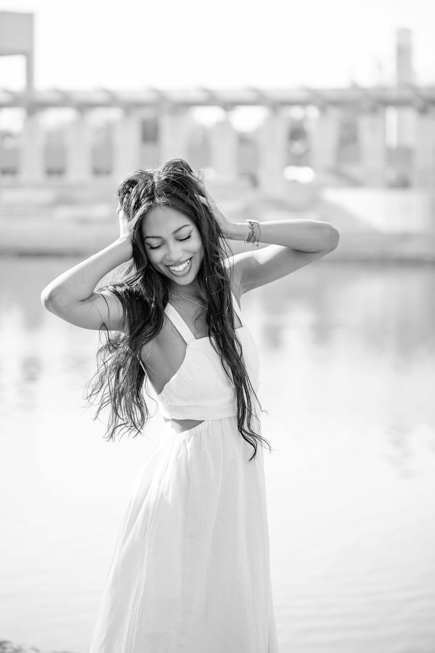 Black and white portrait series showing carefree movement in flowing white dress.