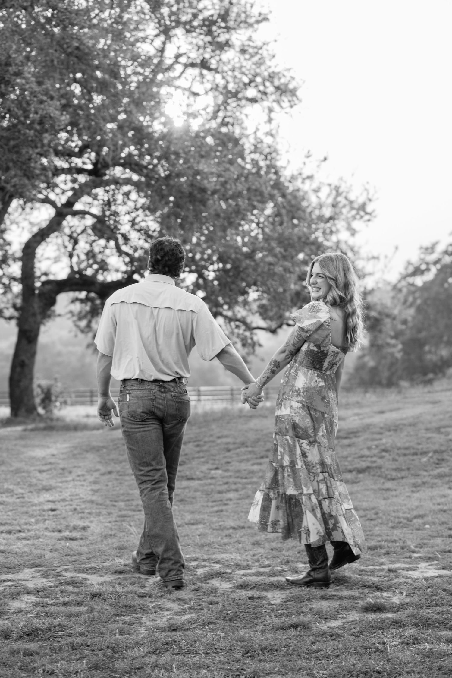 A series of black and white photos showing people walking together up a grassy hill on a sunny day.