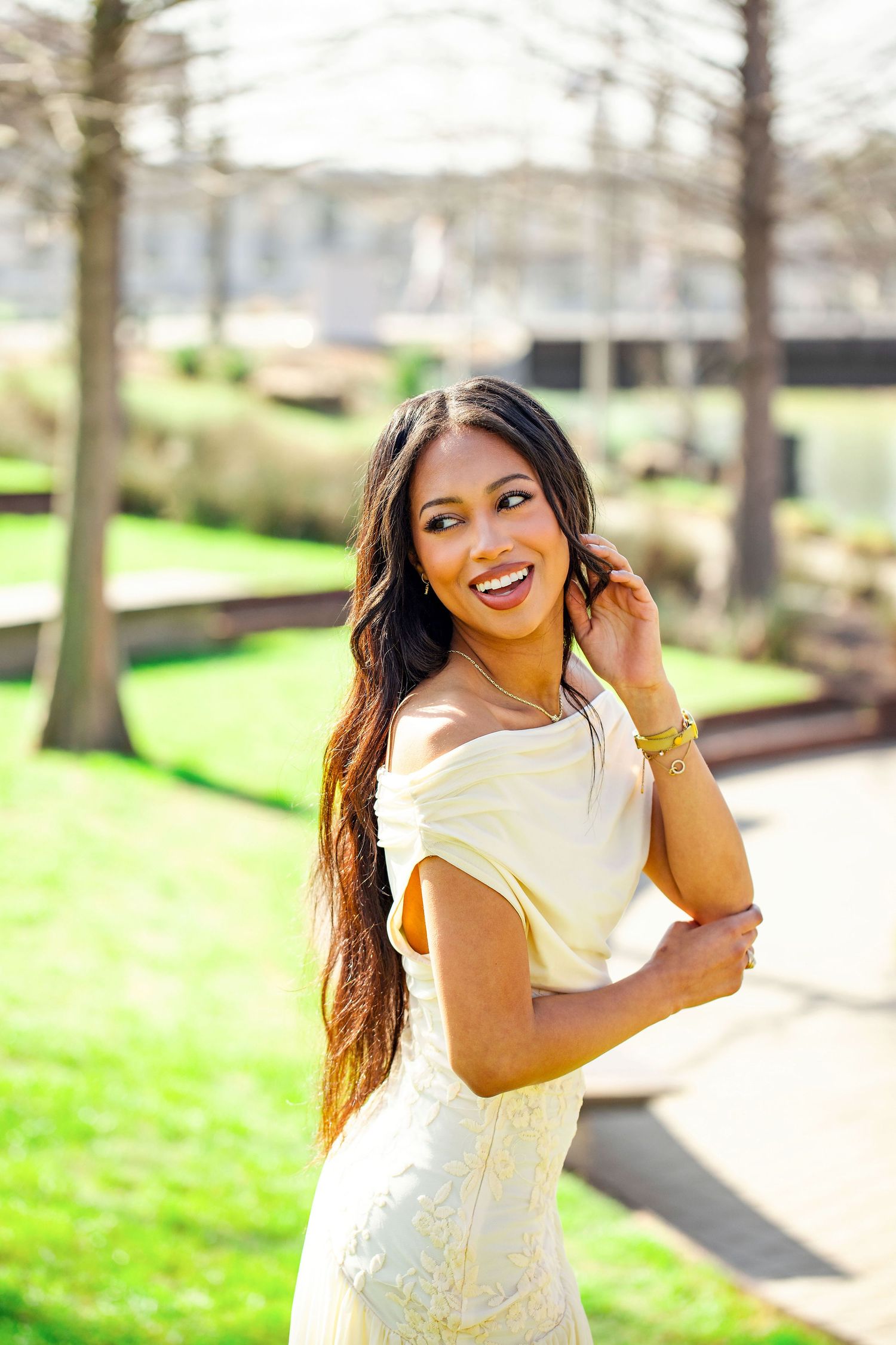Outdoor graduation photos with natural sunlight and green spring background.