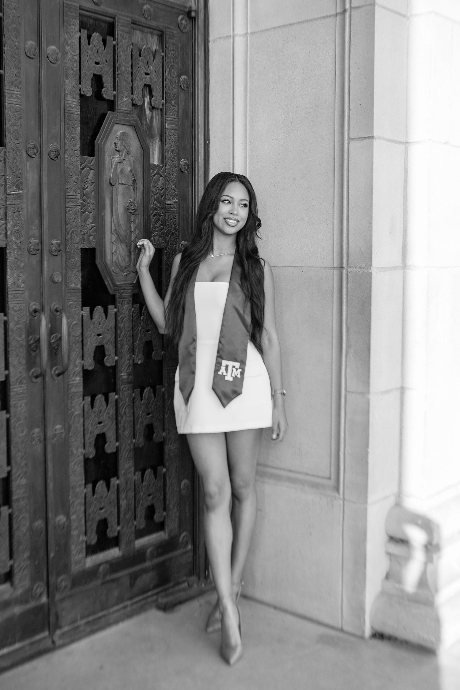Black and white graduation photos taken in front of ornate wooden doors.
