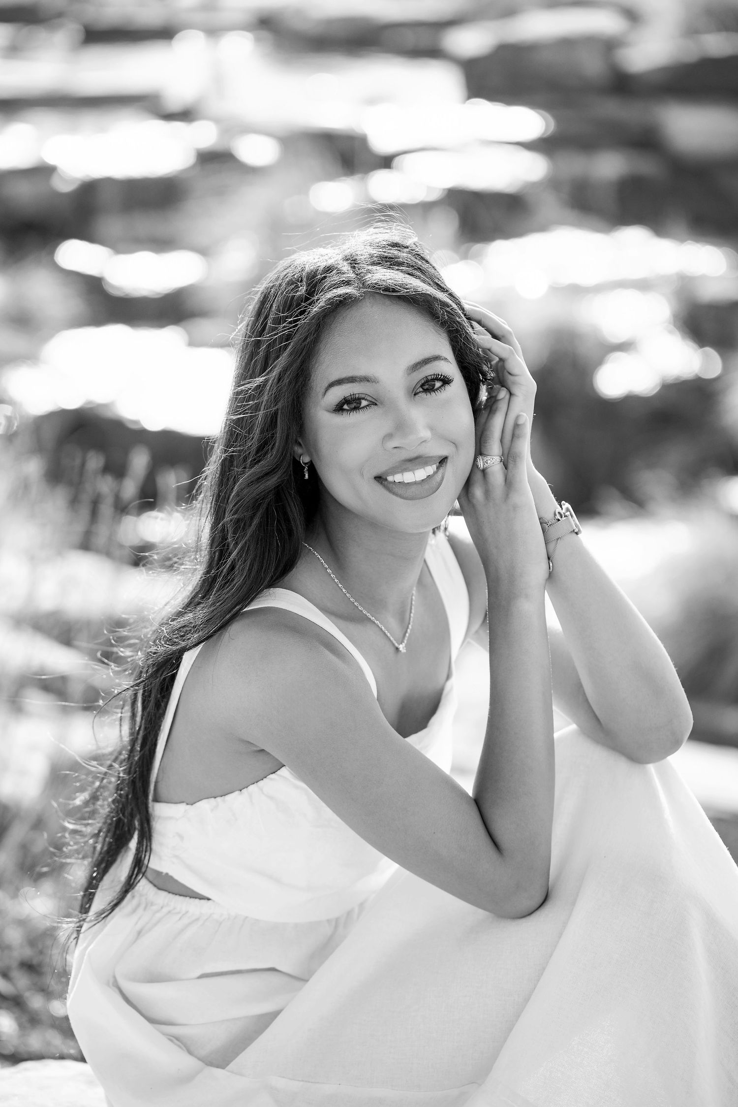 A series of black and white portraits showing playful expressions and poses against a blurred background.