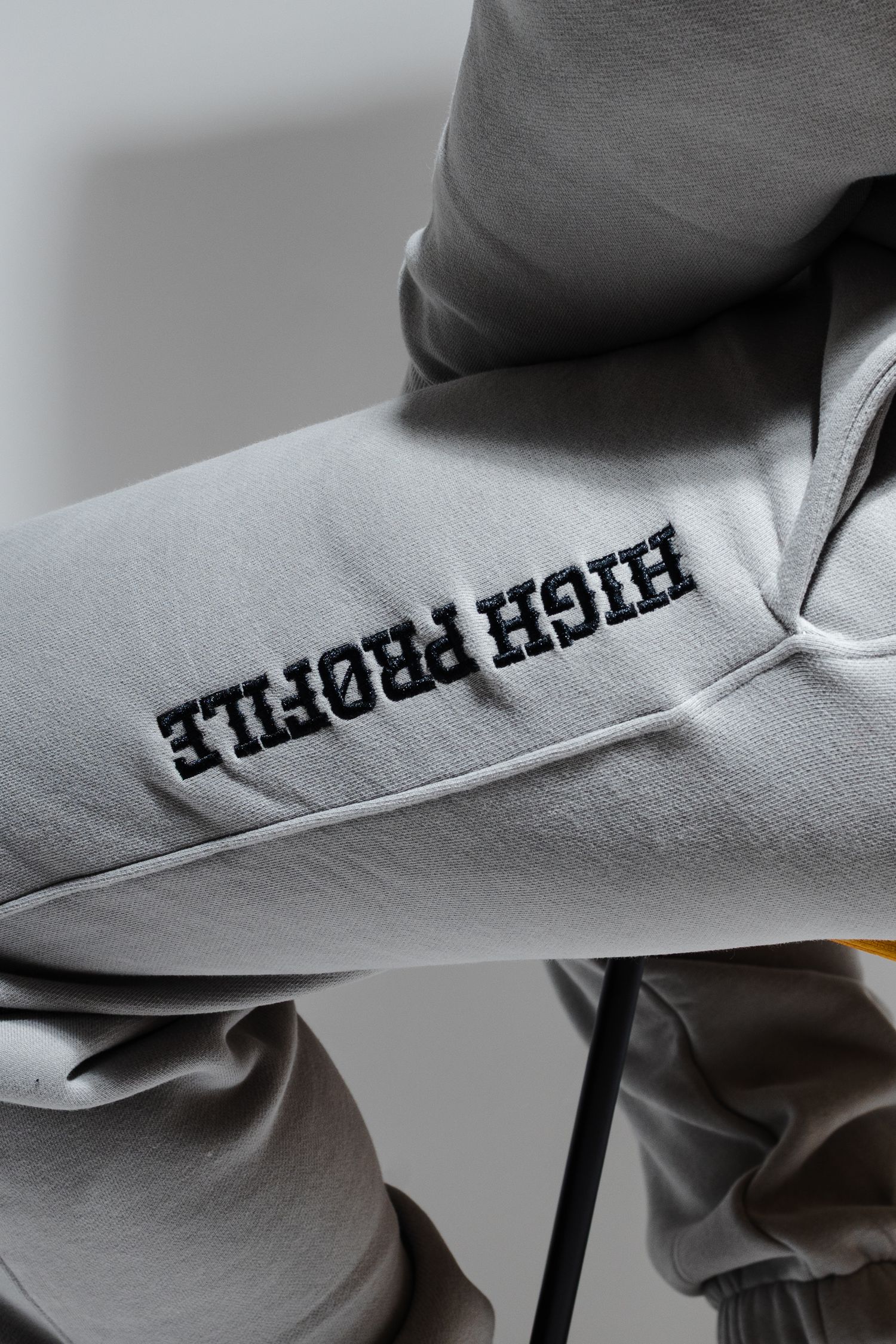 Close-up macro shots of text printed on gray fabric showing partial letters and typography details.