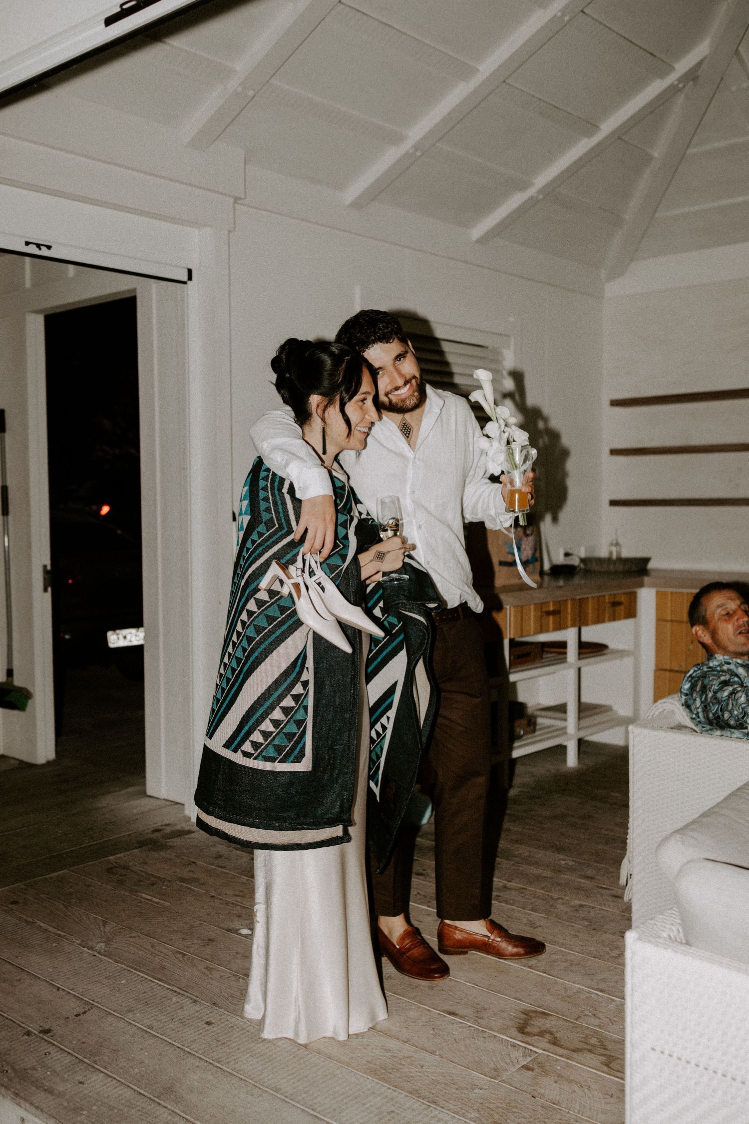 Intimate dance scene in white room with minimalist decor.