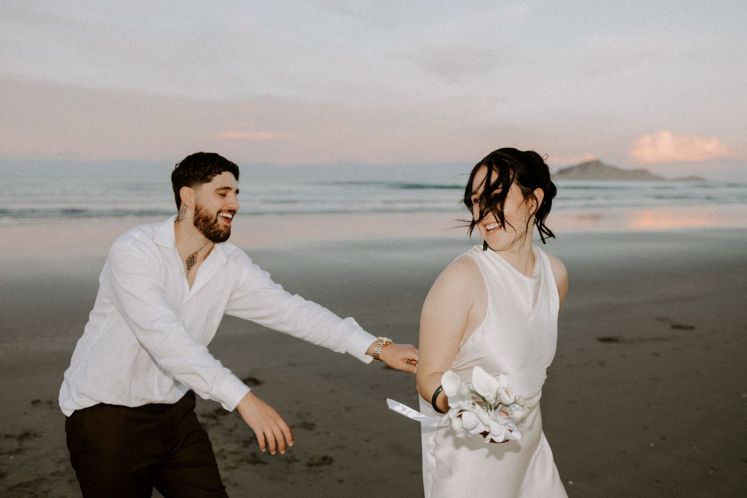 Romantic dance moves captured on a sandy beach during golden hour.