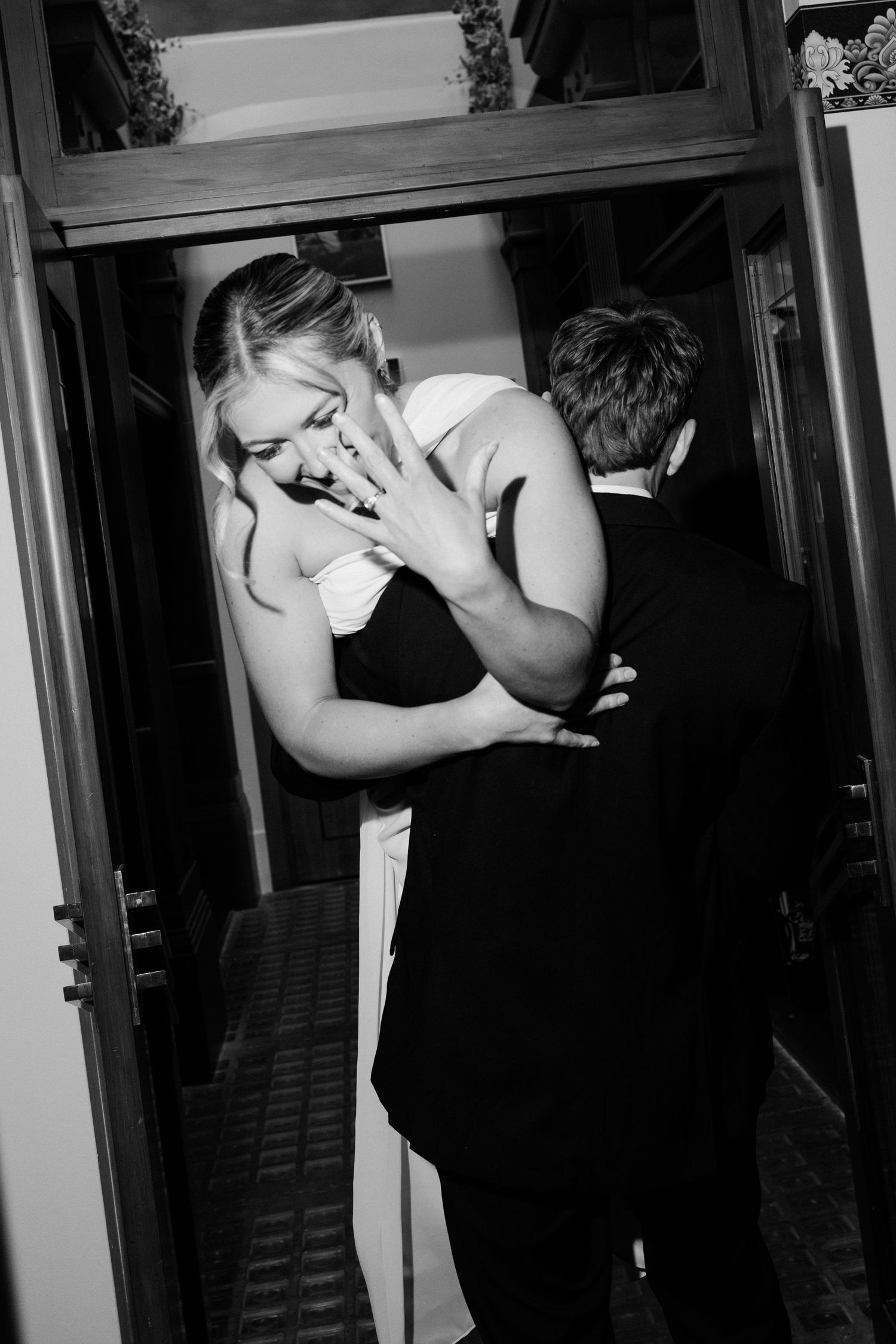 A sequence of black and white photos showing two people in formal attire embracing in an intimate moment.