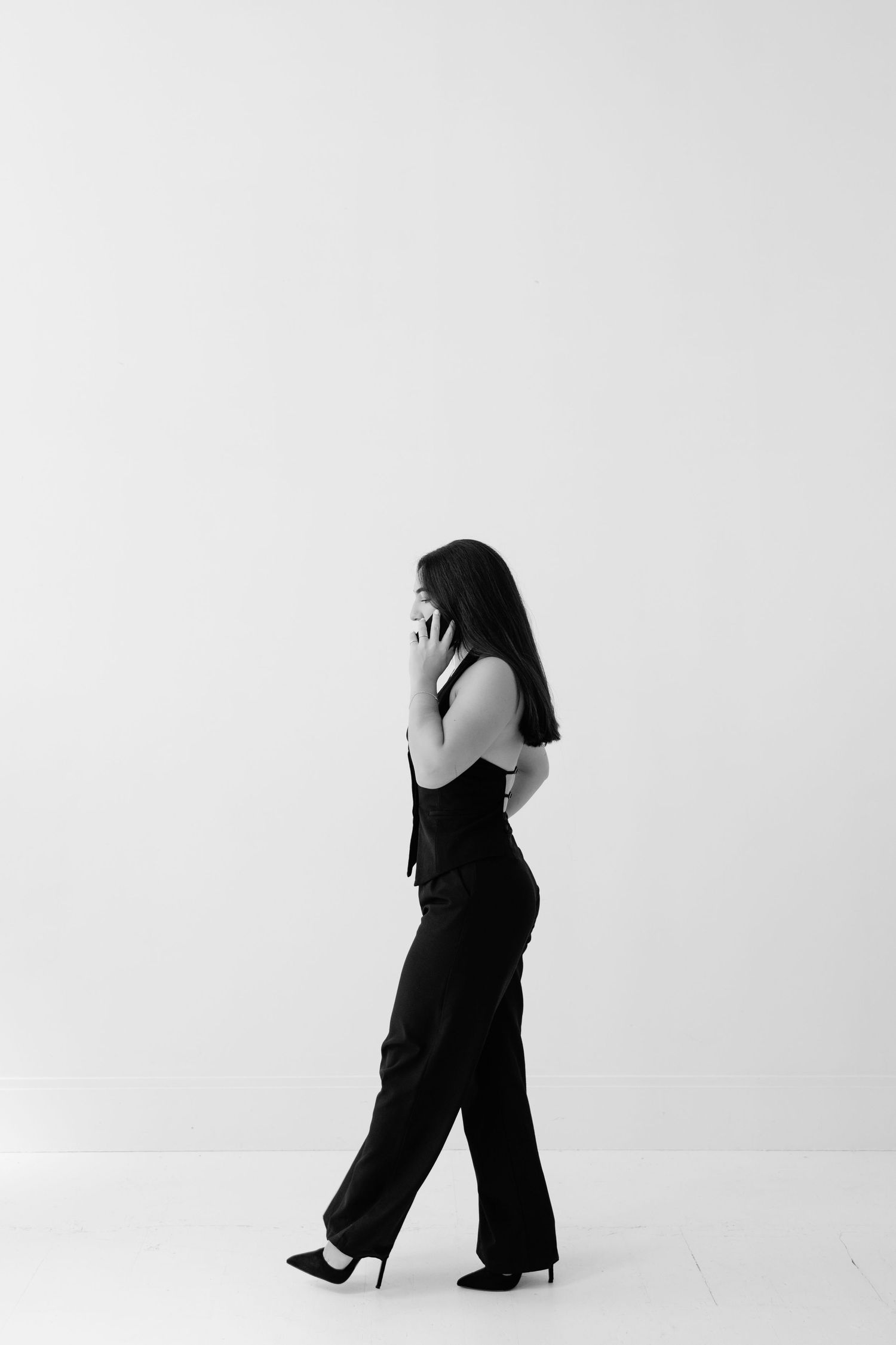 Four minimalist black and white silhouettes show figures in graceful dance poses against a stark white background.