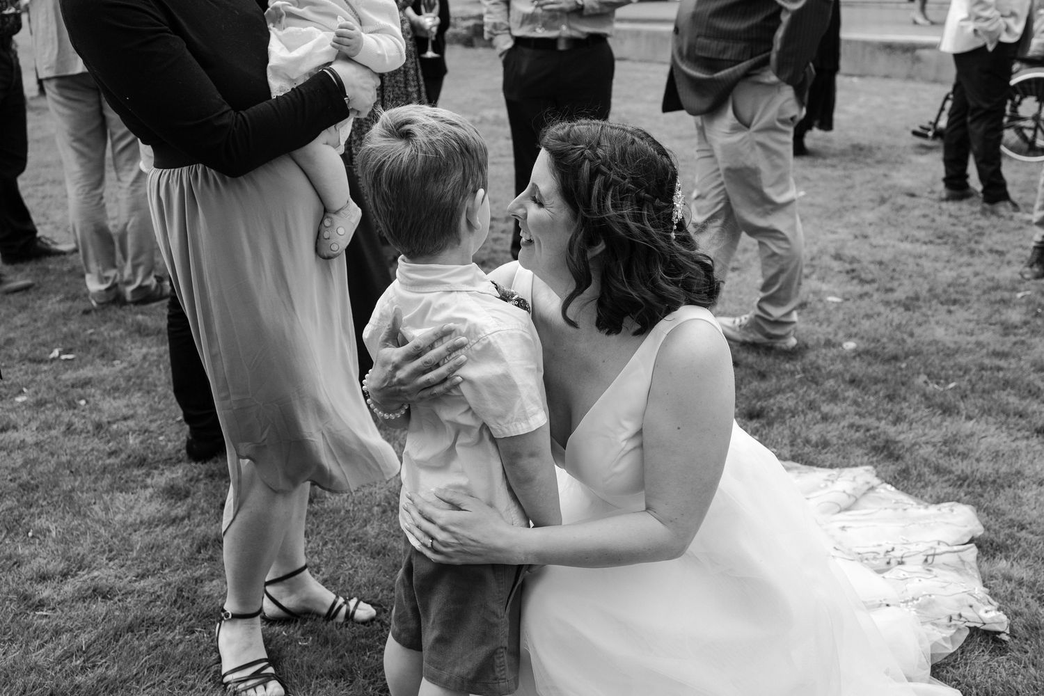 A sequence of black and white photos showing a couple dancing together at an outdoor wedding celebration.