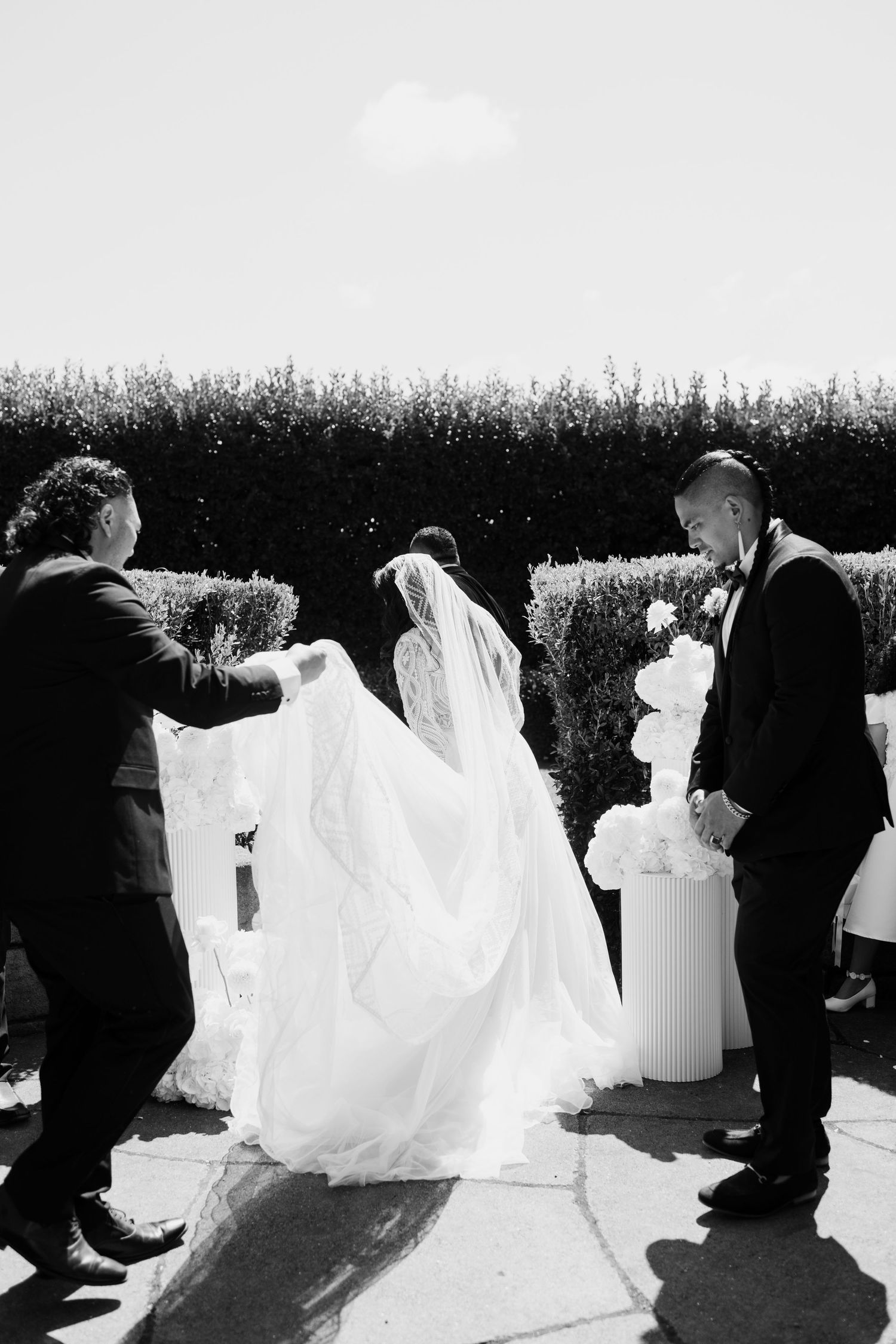 A sequence of artistic wedding photos showing a flowing white dress spinning and twirling in black and white photography.