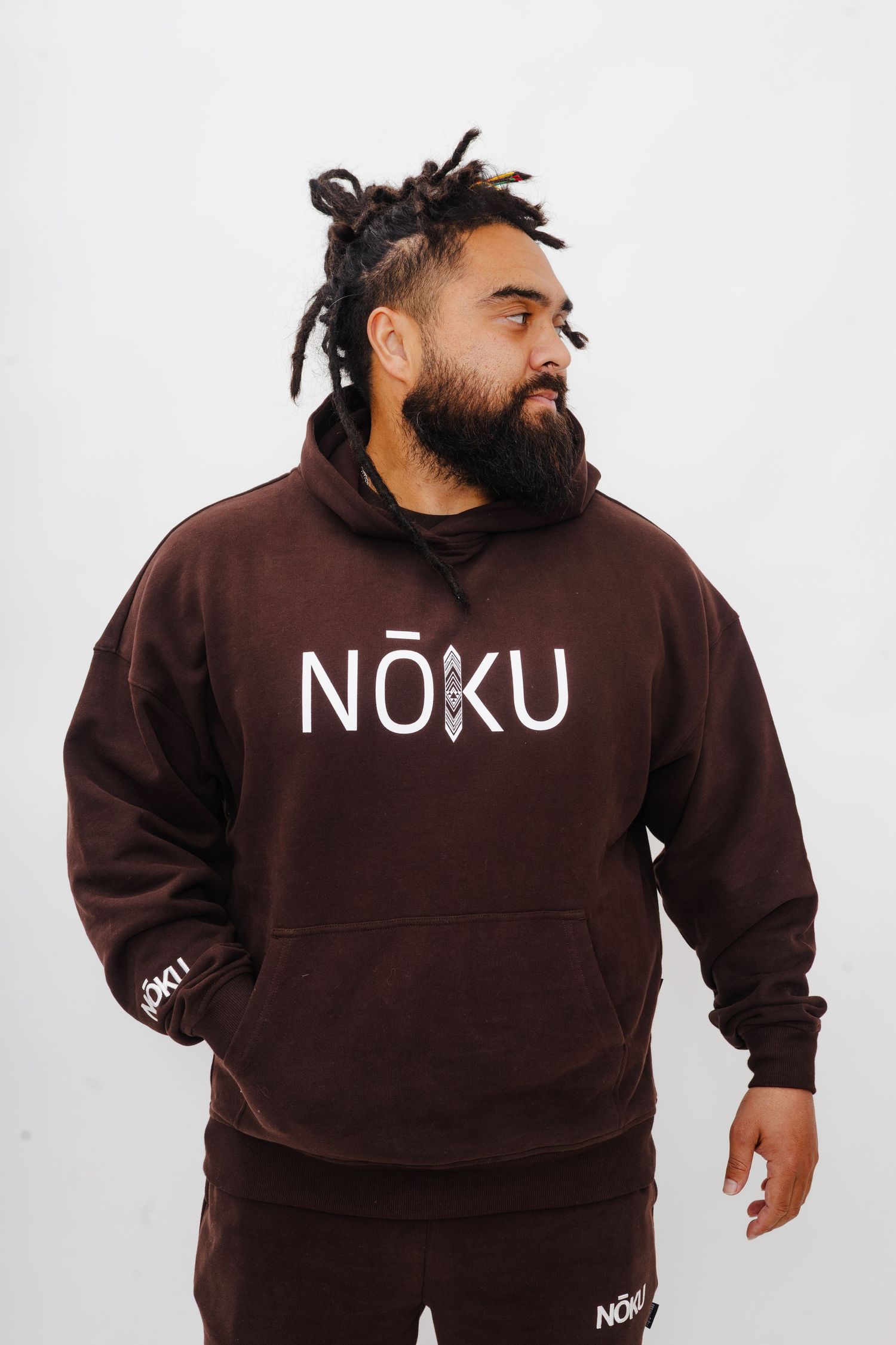 Brown NUKU branded sweatsuit ensemble modeled in multiple poses against white backdrop.