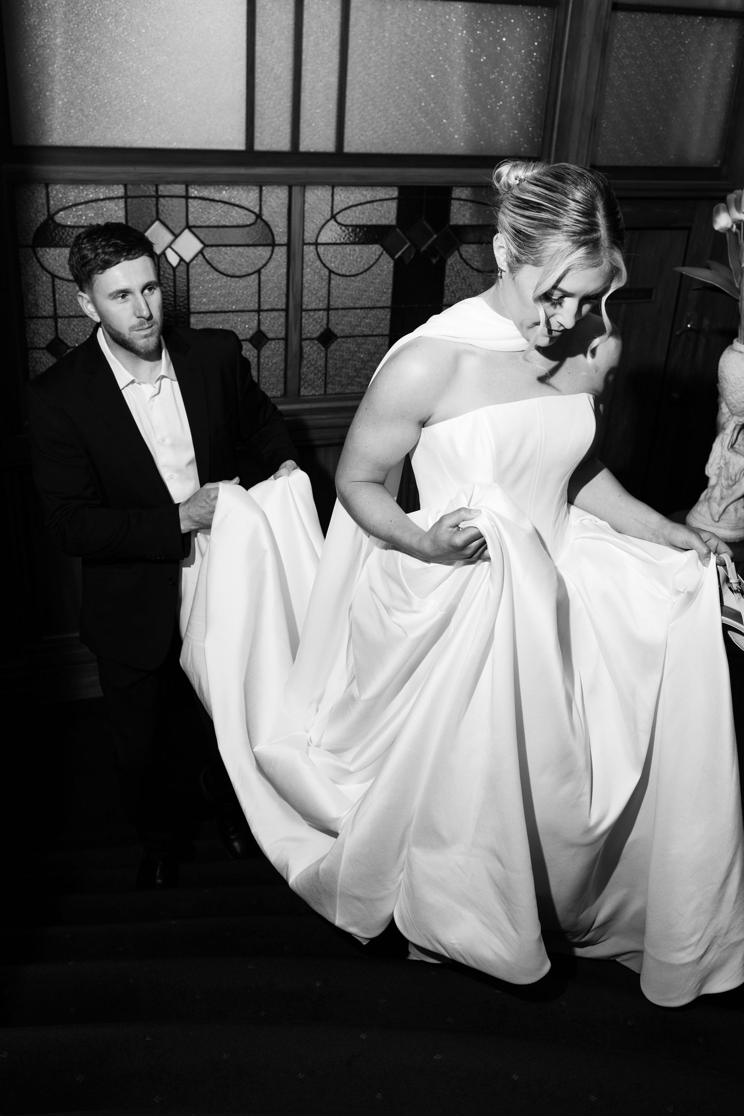 A series of black and white photos showing elegant movement of white flowing fabric against a dark background.