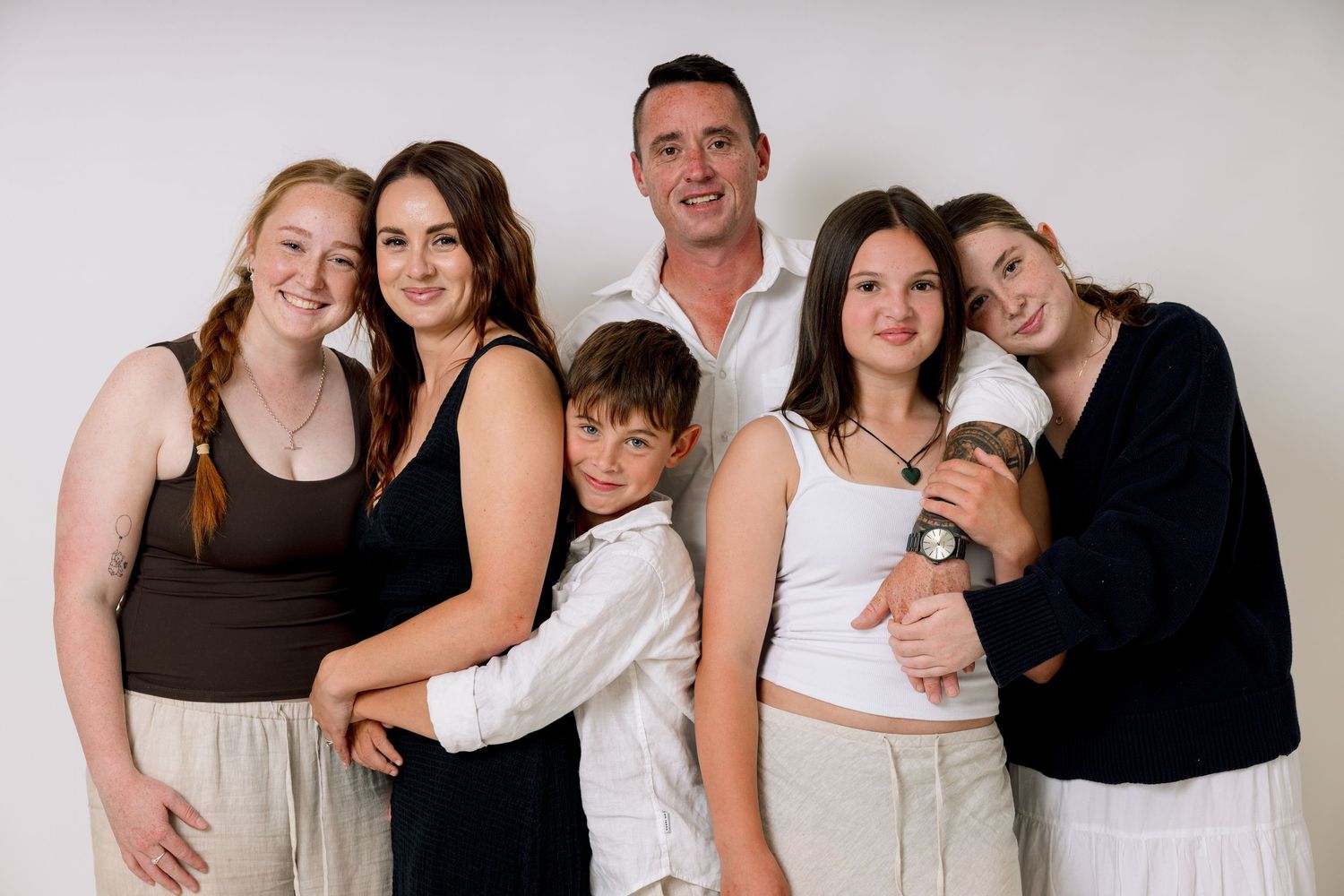 A series of casual family portrait photographs in black and white against a light background.