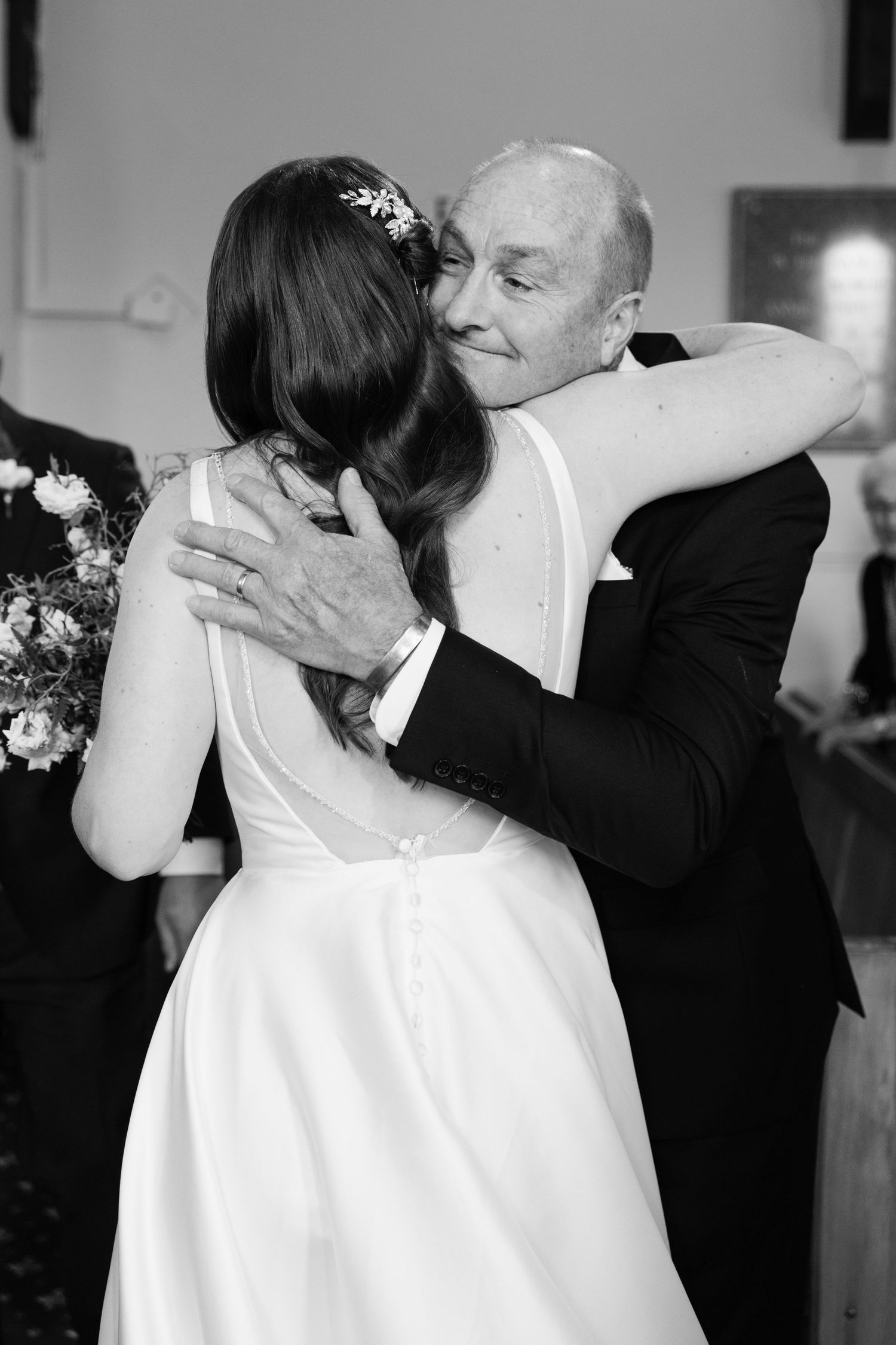 A sequence of four black and white photos showing a romantic dance between a bride in white and her partner at a wedding.