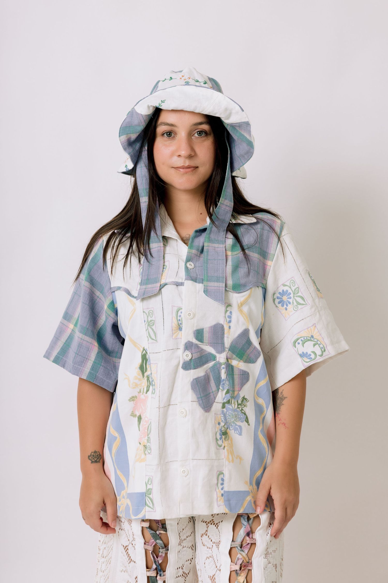A series of photos showing a child wearing a white and pastel patterned vest with a matching sun hat.