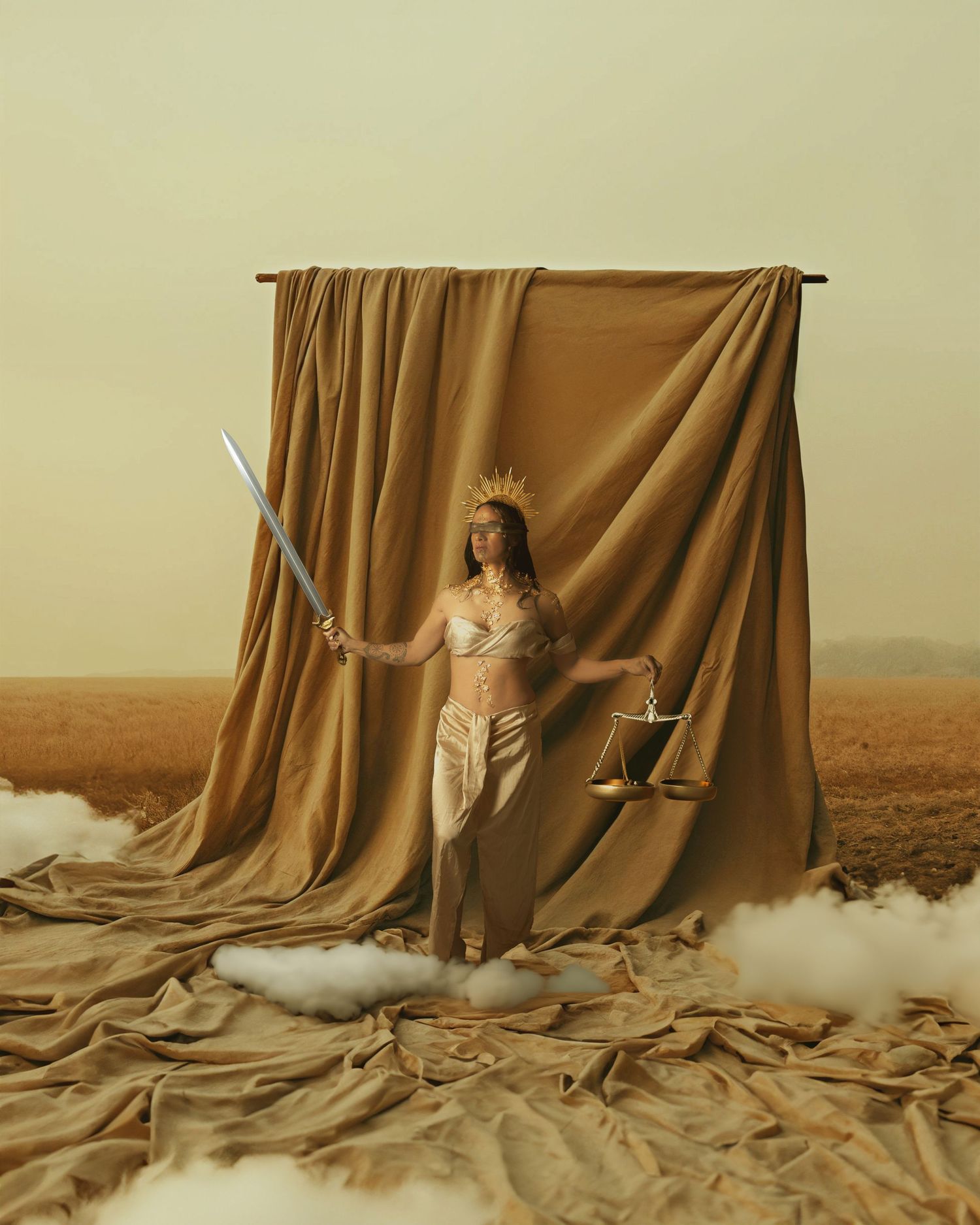 A brown fabric curtain billows and flows across a desert landscape creating an artistic surreal scene.