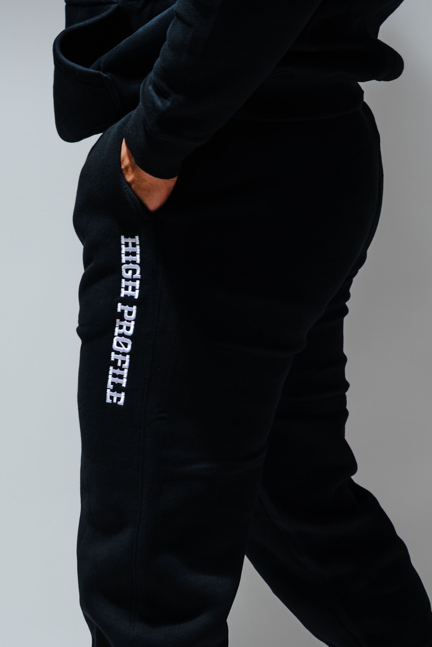 Athletic wear in black with white lettering showcasing close-up details of a street fashion hoodie.