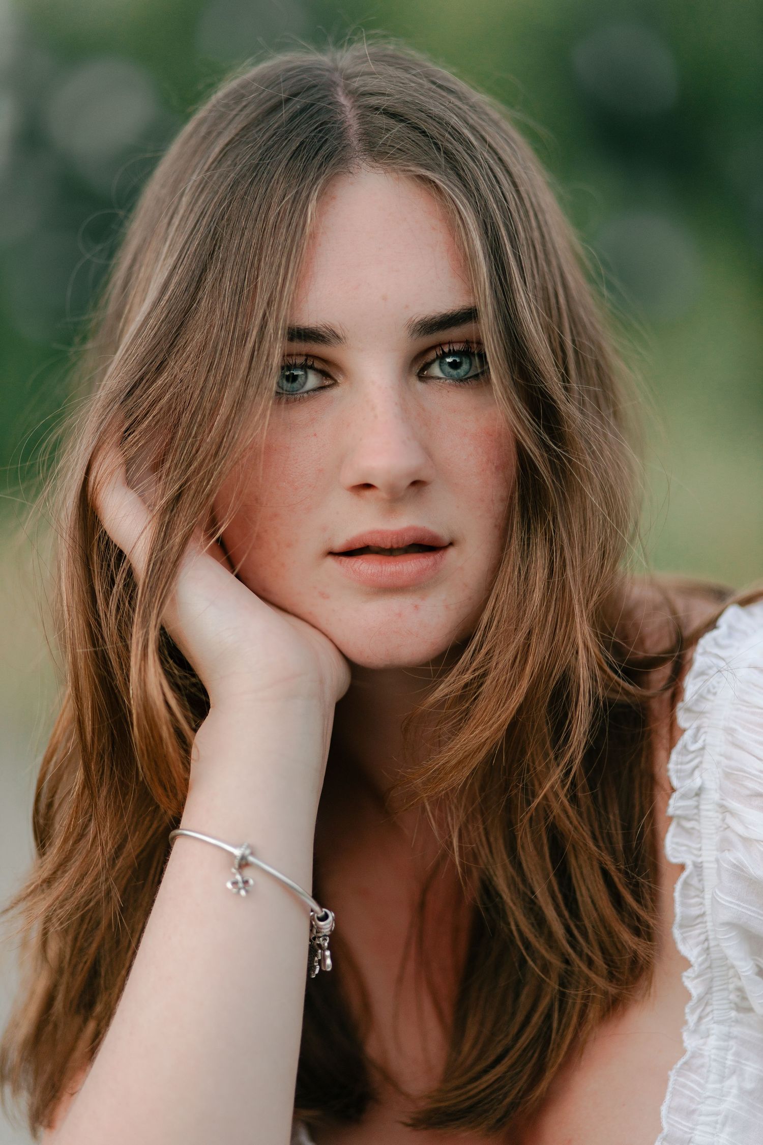 A series of close-up portrait photos showing someone with brown hair wearing white lace against a soft natural background.
