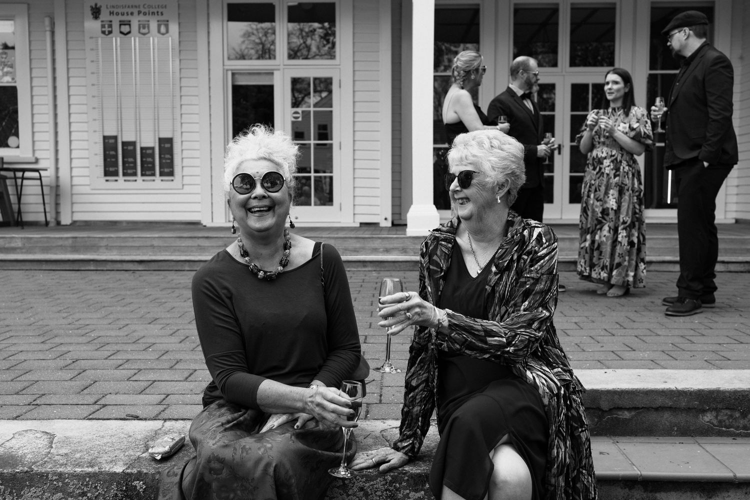 A series of black and white photographs showing people interacting at what appears to be a historic building or museum.
