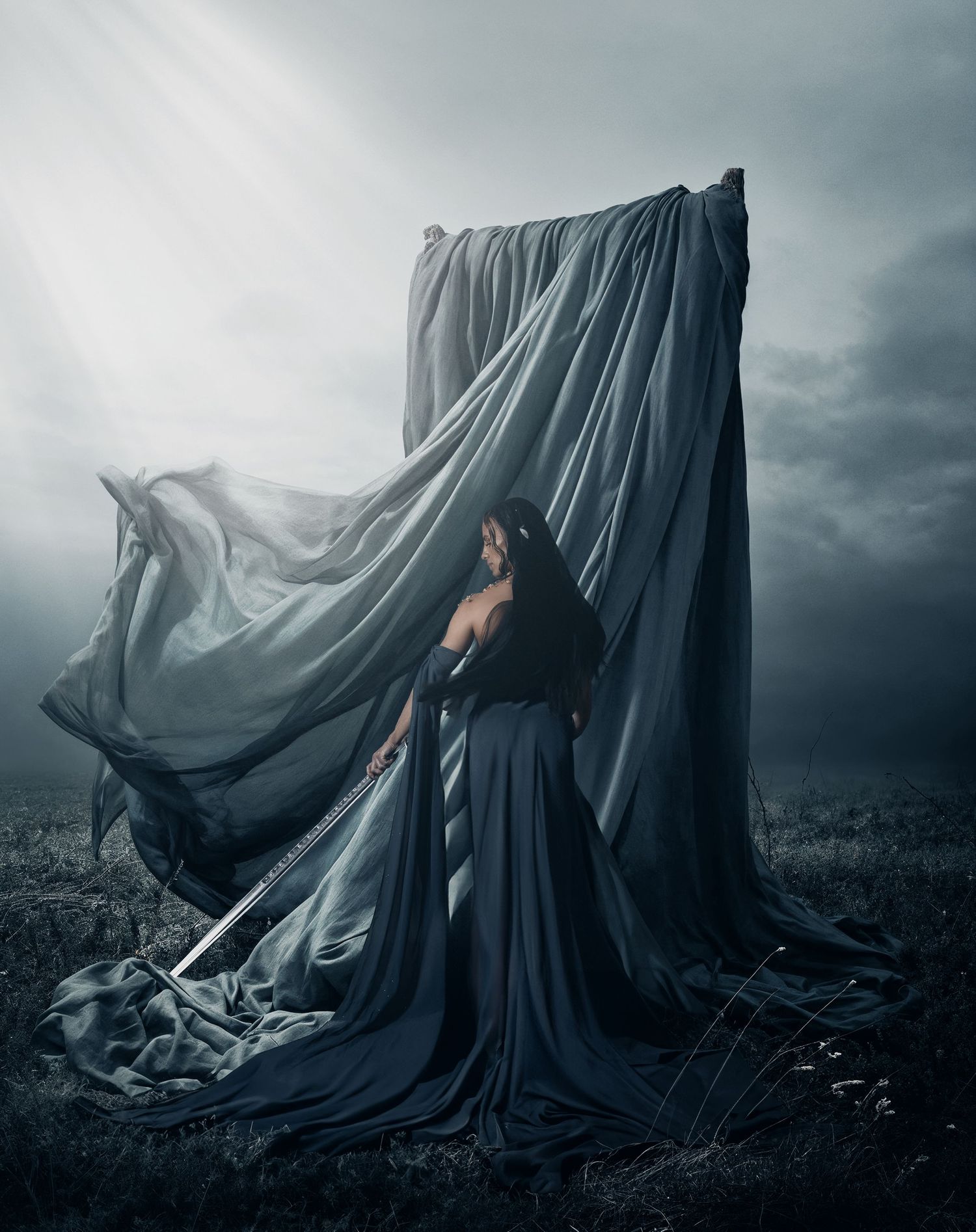 A dark and moody artistic photo sequence shows a figure draped in flowing black fabric against a stormy landscape.