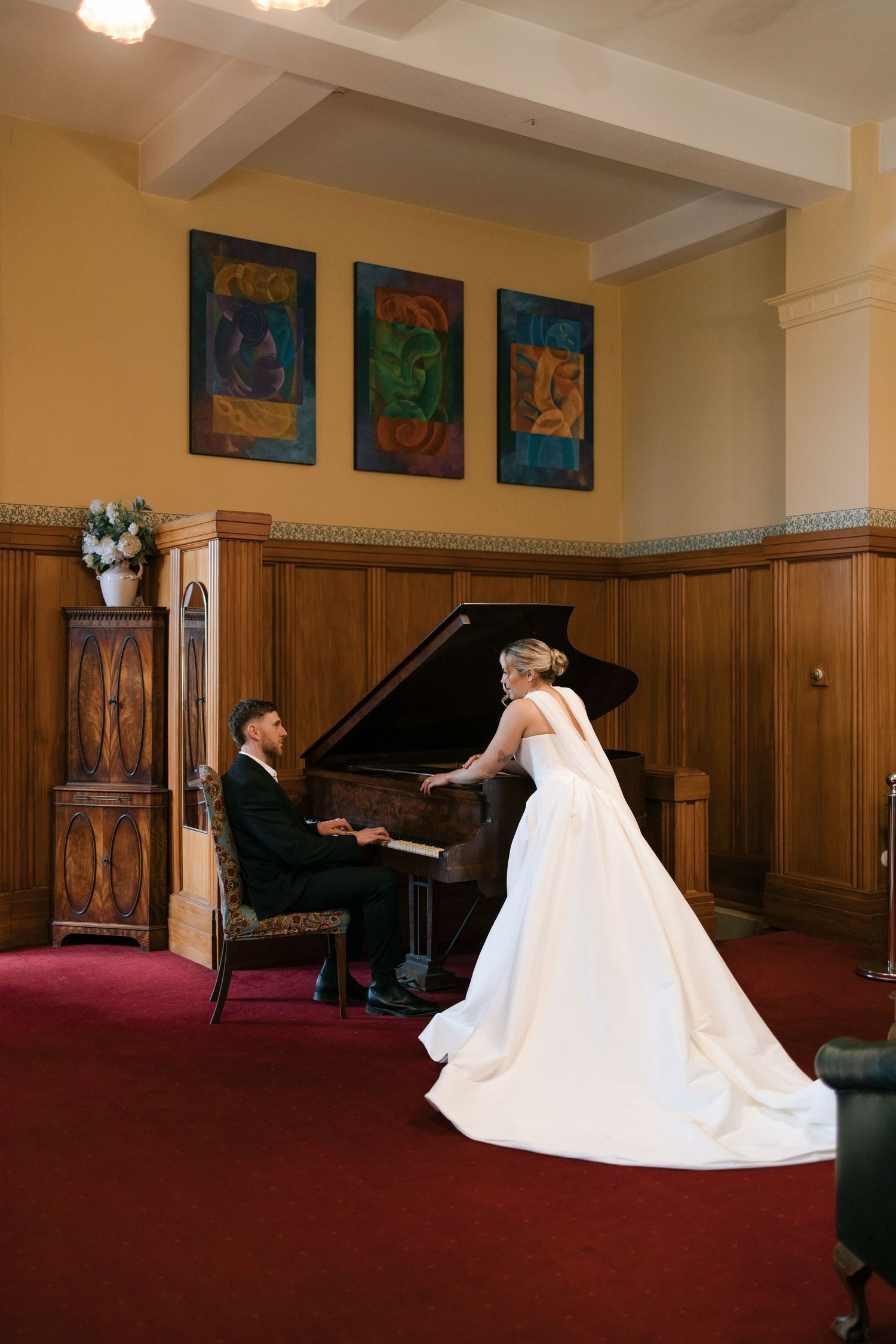 A series of photos showing a bride in a white ballgown posing in an elegant wood-paneled room with artwork and piano.