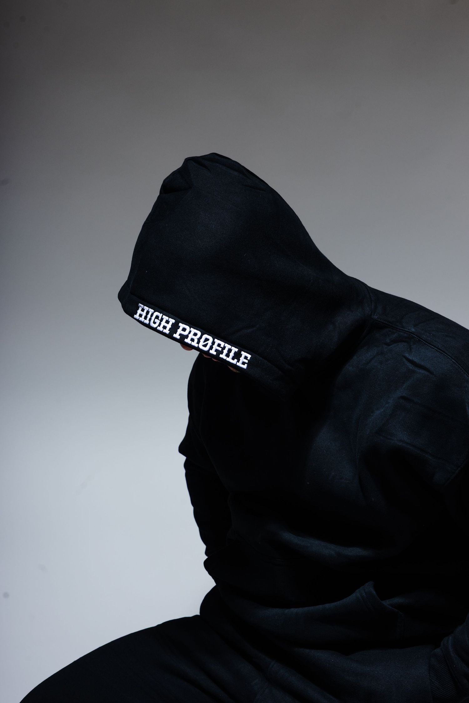 Person wearing black hoodie with 