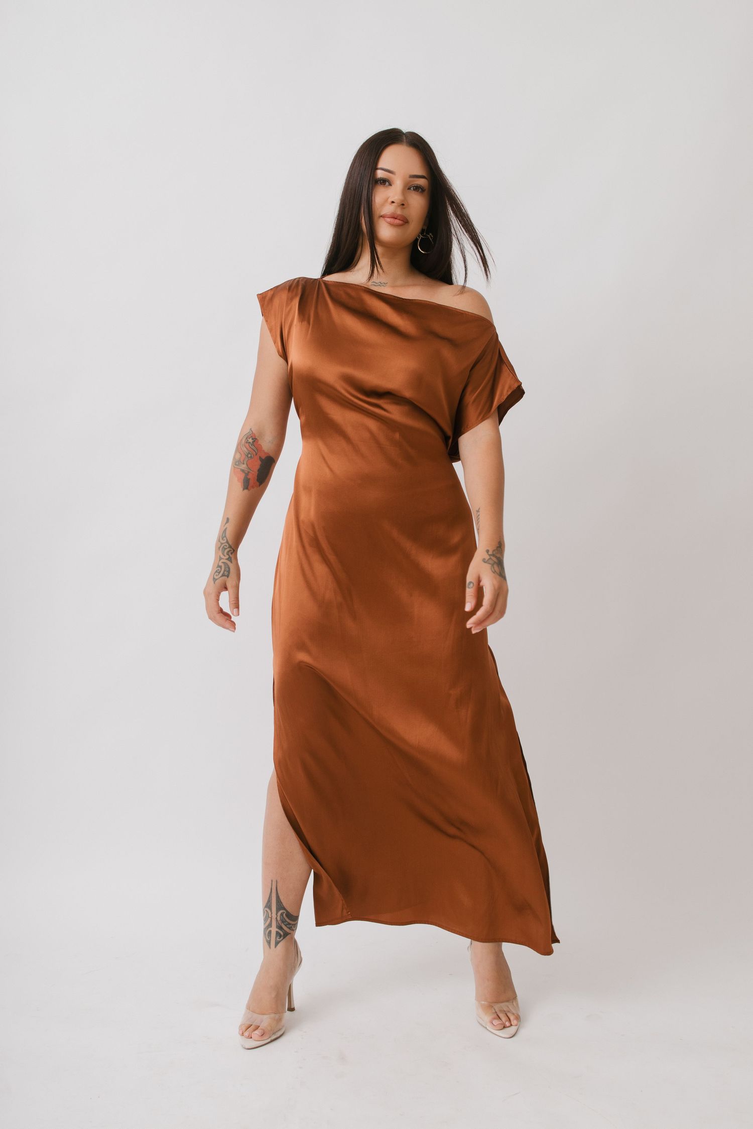 A rusty brown silk dress shown in different angles on a white background with minimalist styling.
