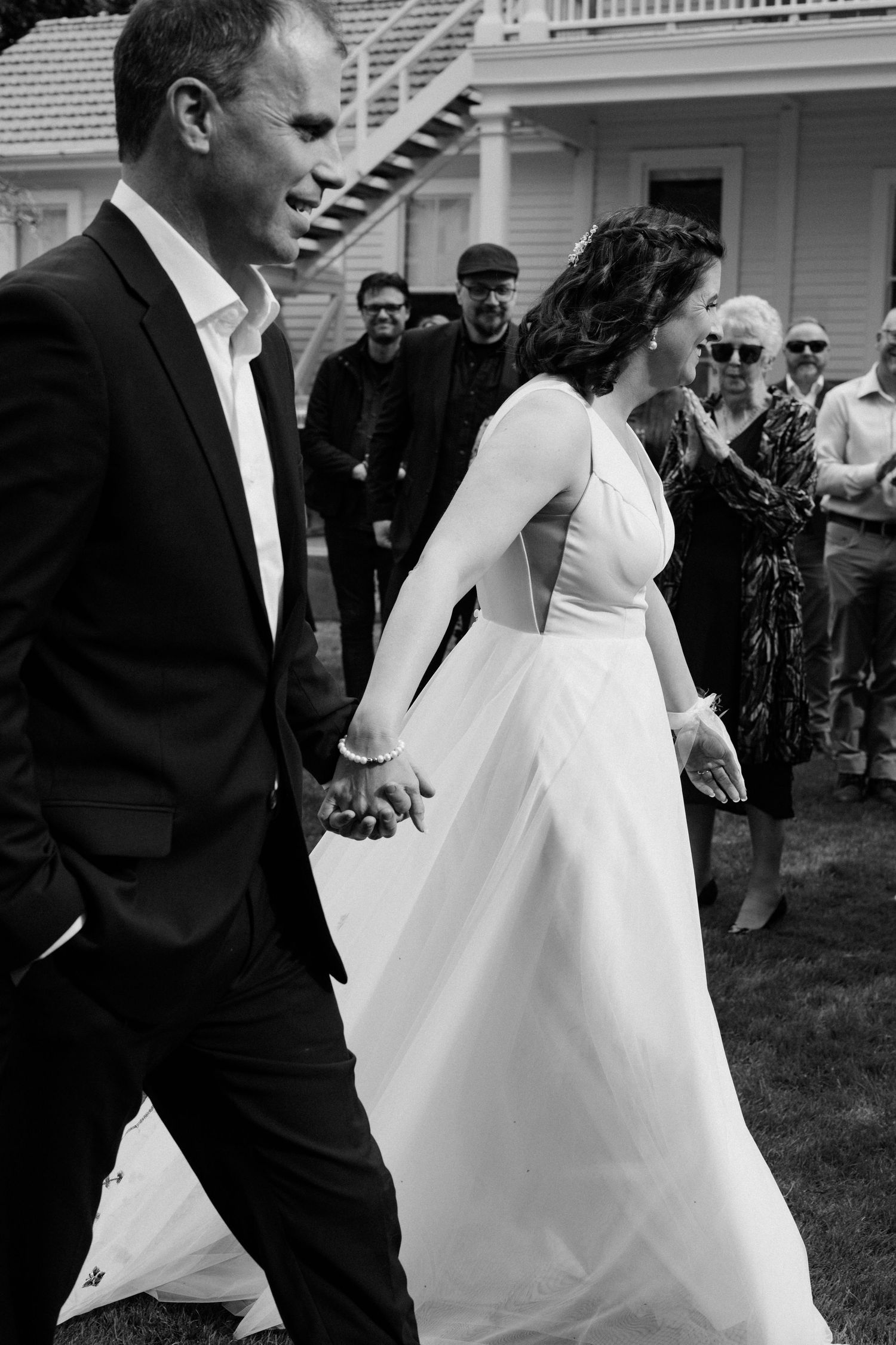 A sequence of black and white wedding photos showing a couple walking together on their special day.