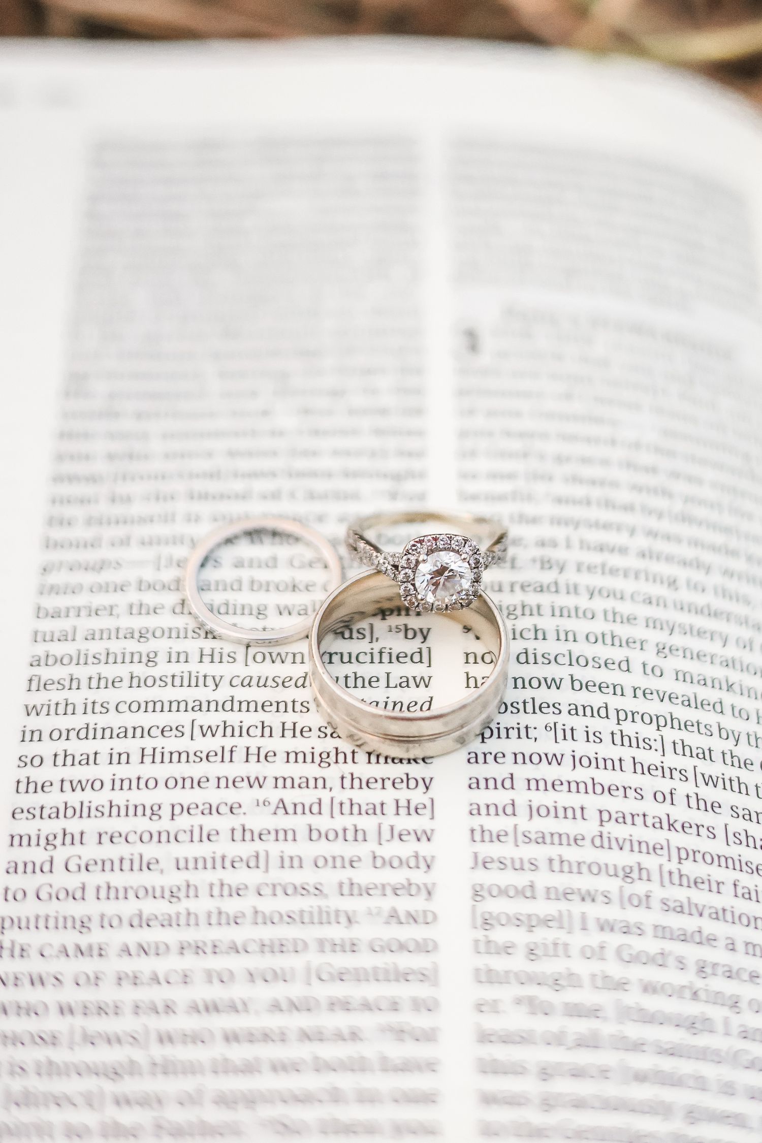 Wedding rings resting on an open Bible page, symbolizing faith and commitment in marriage.