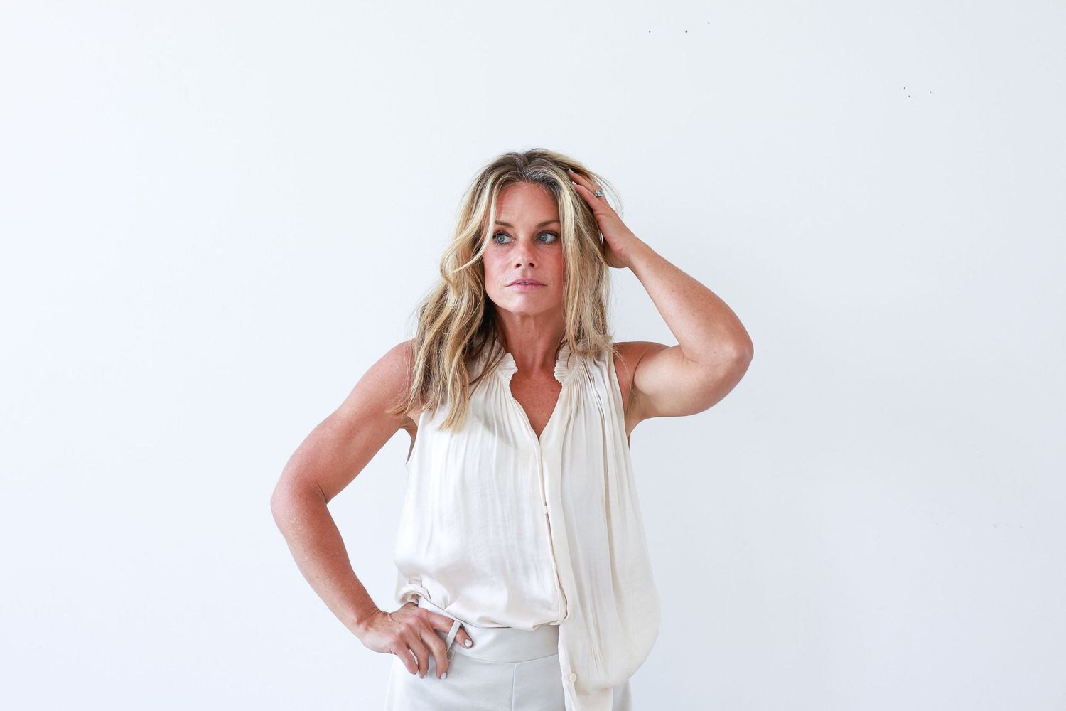 A person with blonde hair wearing a white top poses in a series of dynamic fashion shots against a light background.