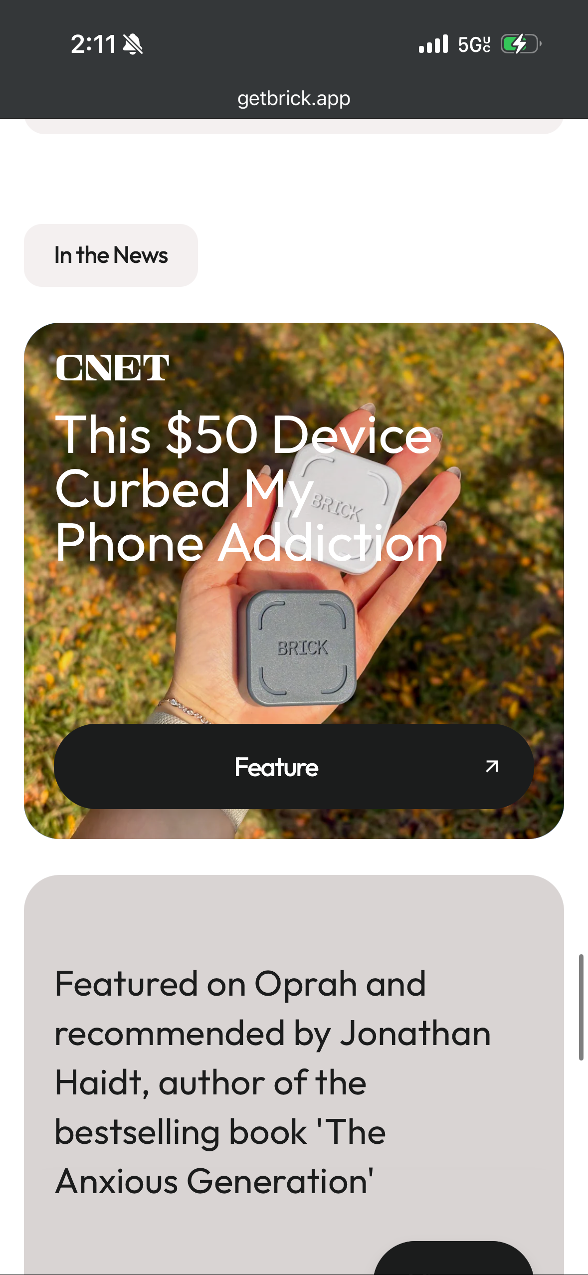 CNET feature article showing a hand holding the Brick device, a $50 gadget designed to curb phone addiction.