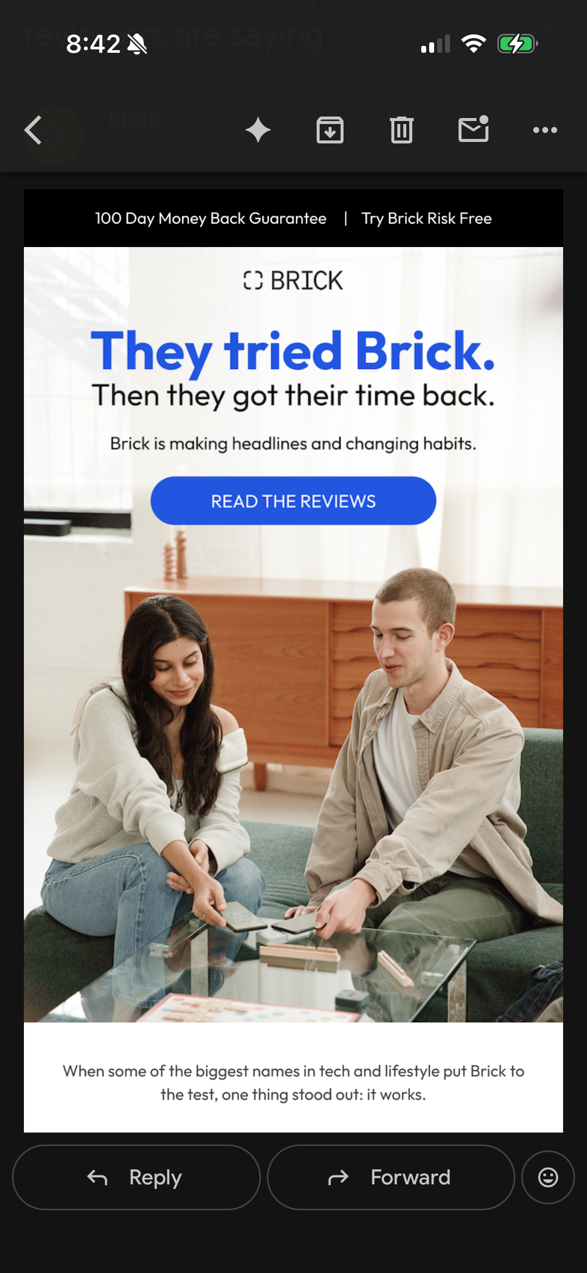 Two people sitting on a couch engaging with Brick, a screen-time management device, in a modern living room setting.