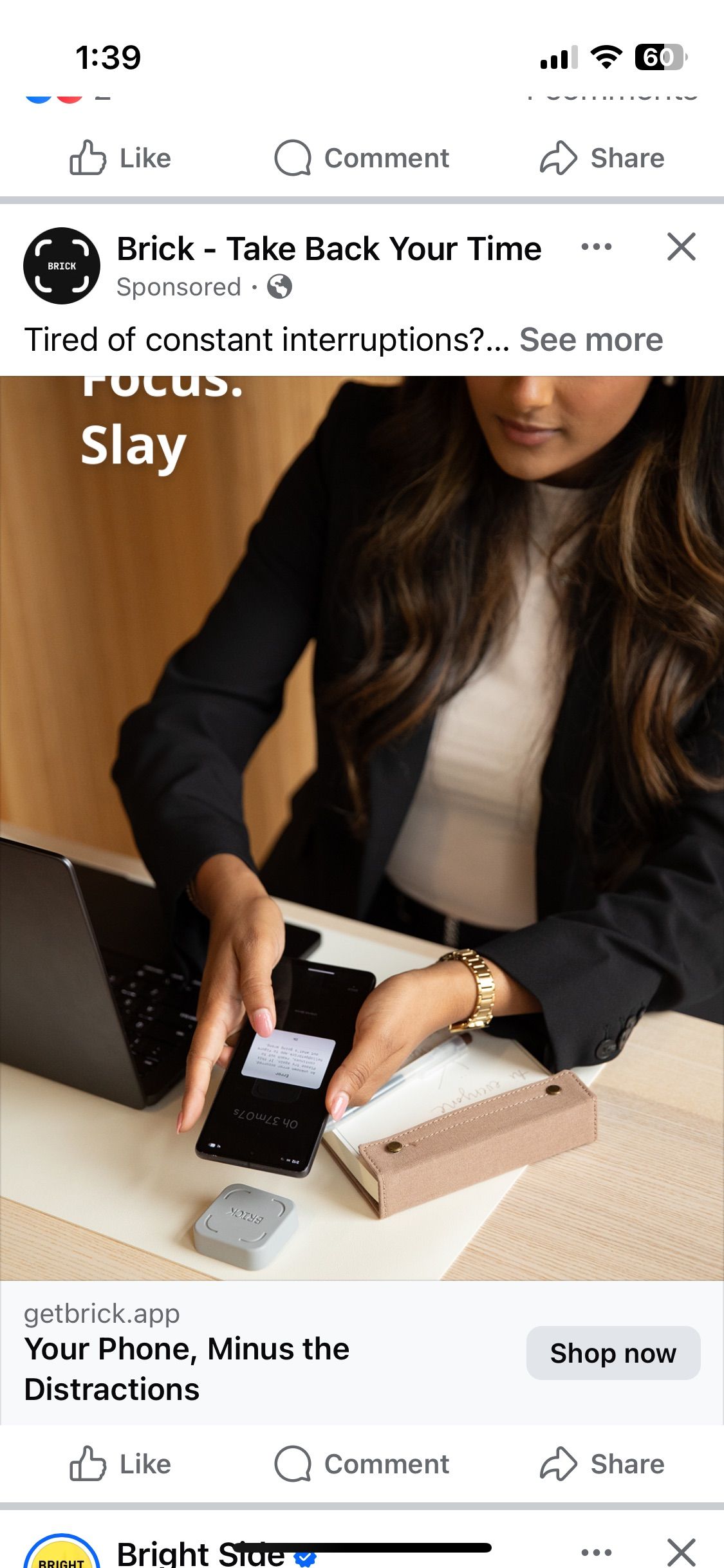 Woman at desk using smartphone next to Brick device, a distraction-blocking tool, with laptop and packaging nearby.