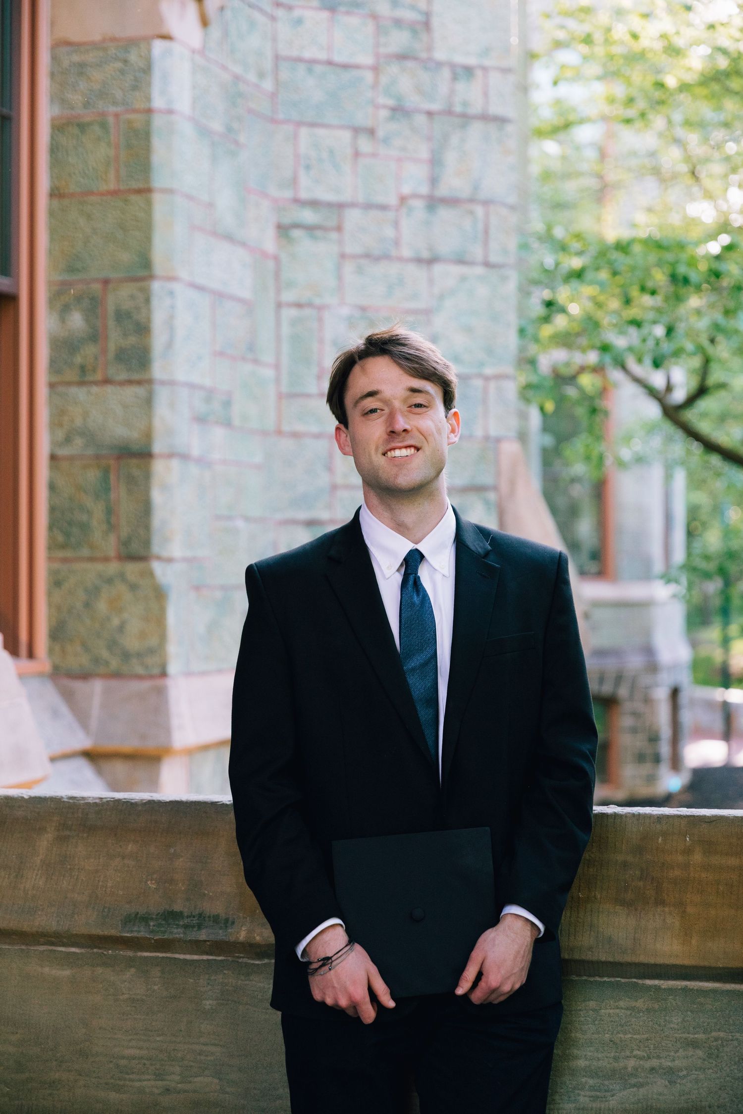 Progressive portrait series showing person in black suit against stone building backdrop.