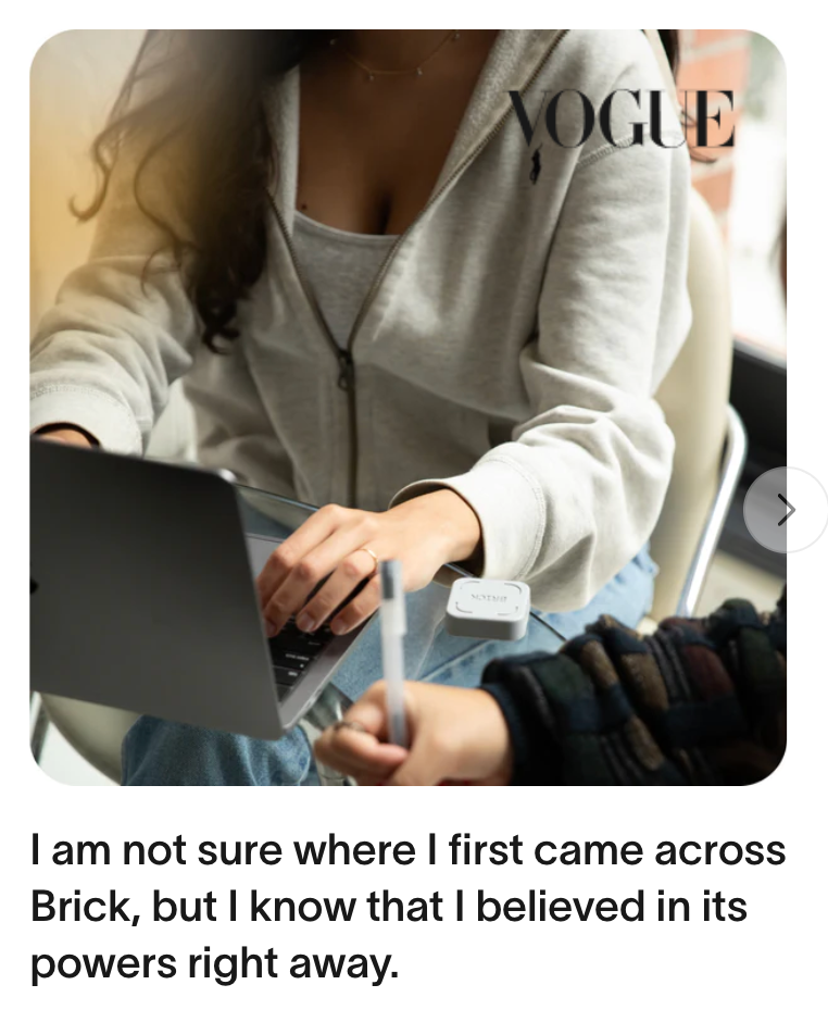 Woman using laptop while holding a Brick device, featured in Vogue magazine article about productivity tools.